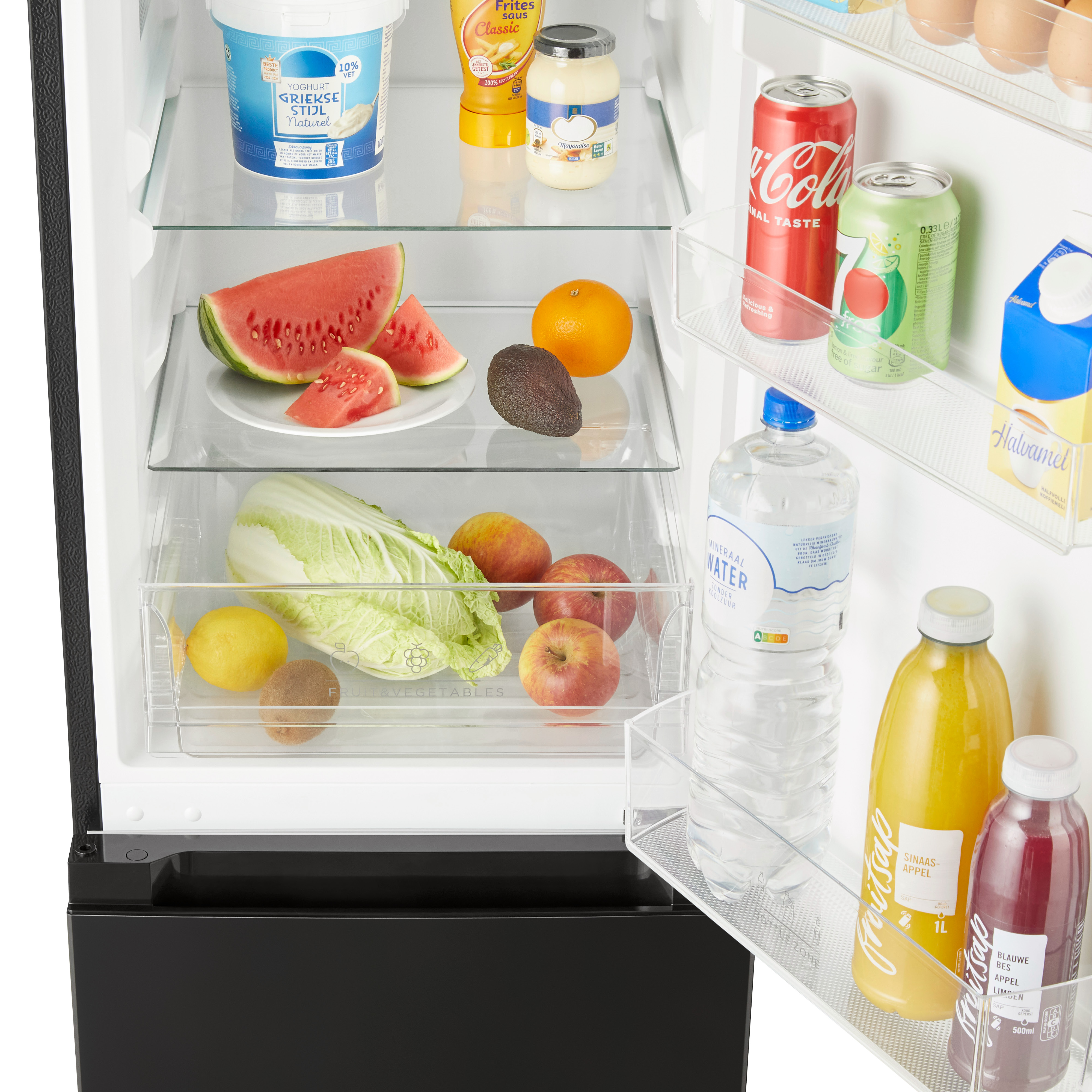 Refrigerator interior with food items including watermelon, orange, and vegetables.