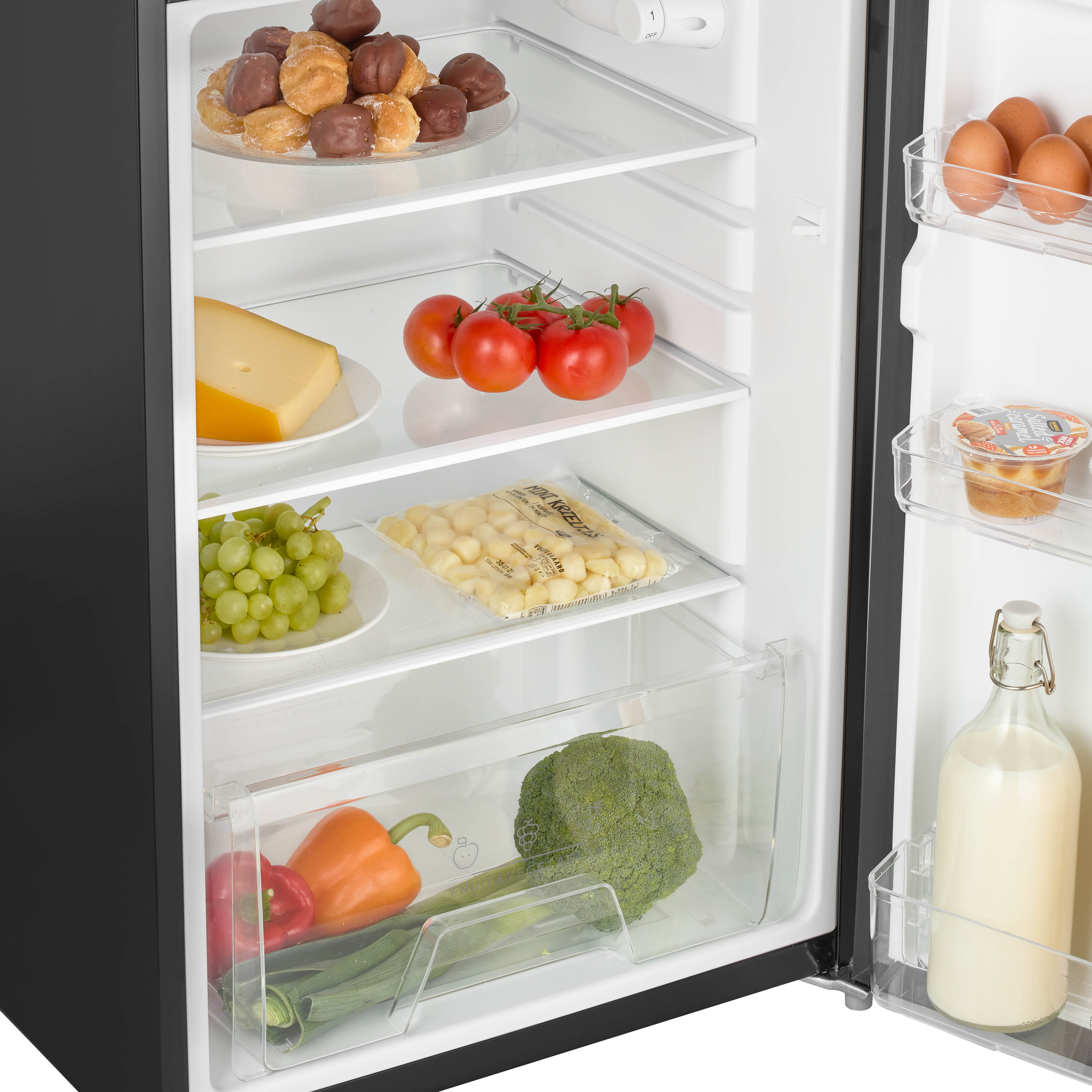 Open refrigerator with food: cheese, tomatoes, grapes, gnocchi, broccoli, peppers, and milk.