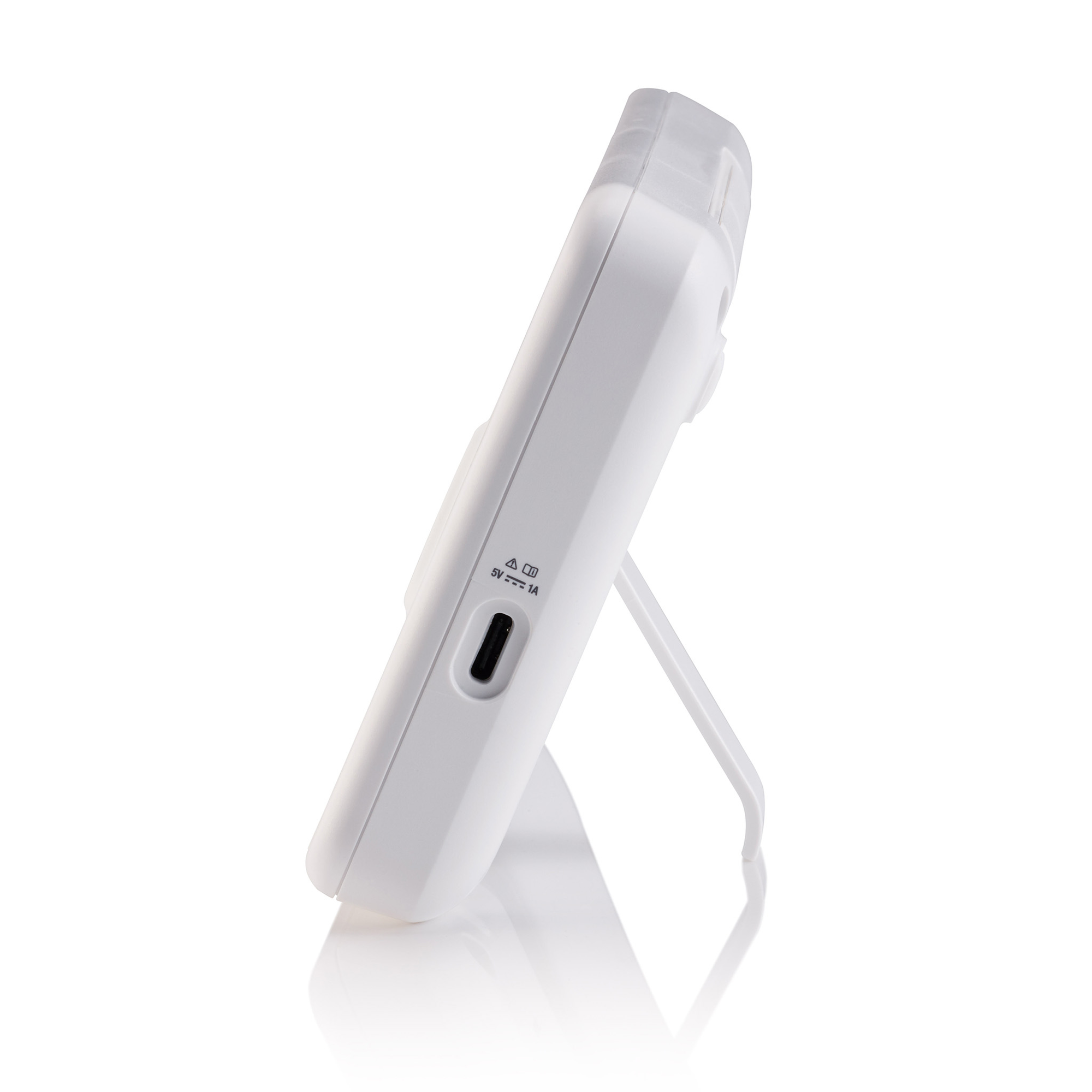 A white device standing upright, with a charging port and a stand. It has a panel with icons.