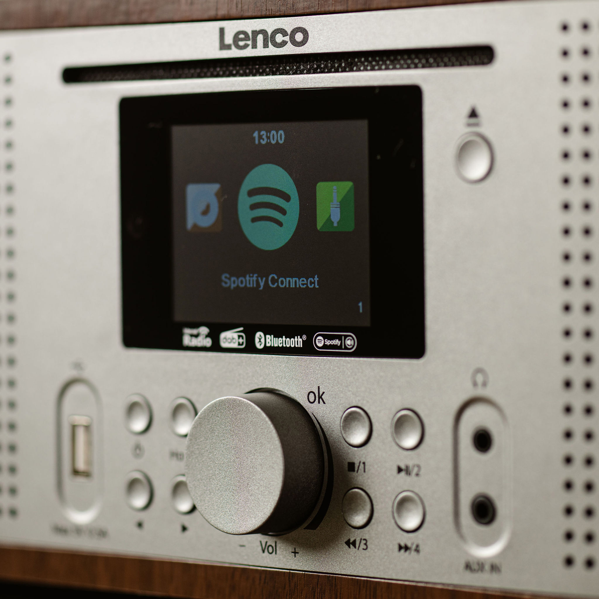 Dispositivo audio argento, display Spotify Connect, pulsanti.