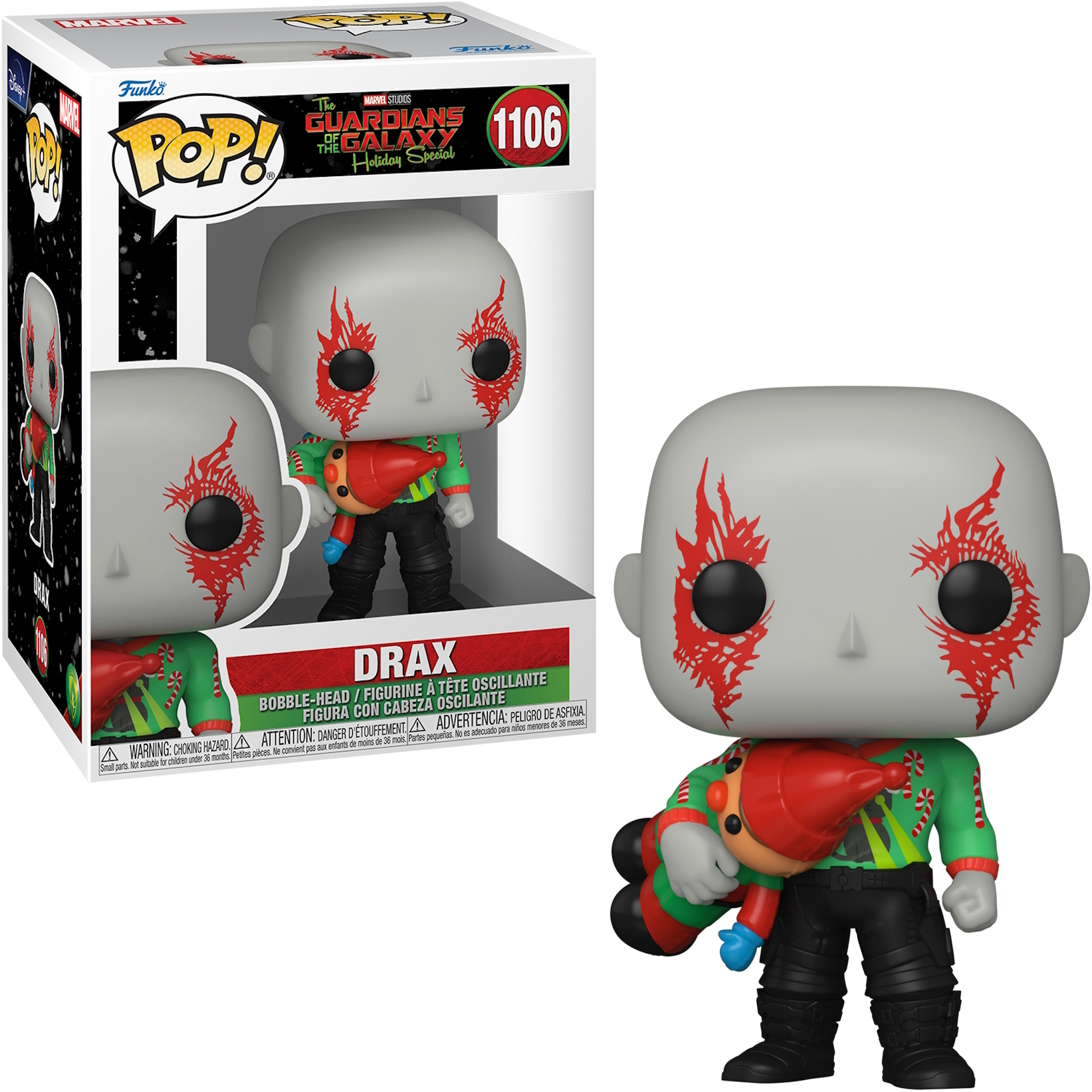 Figurka Funko Pop Draxa z Strażników Galaktyki. Trzyma małą lalkę i ma na sobie świąteczny sweter.