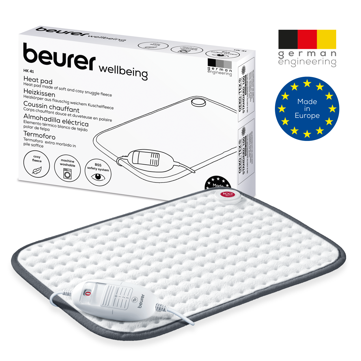 Cuscino termico con scatola. Il cuscino è bianco e ha un bordo grigio. Ha un telecomando.