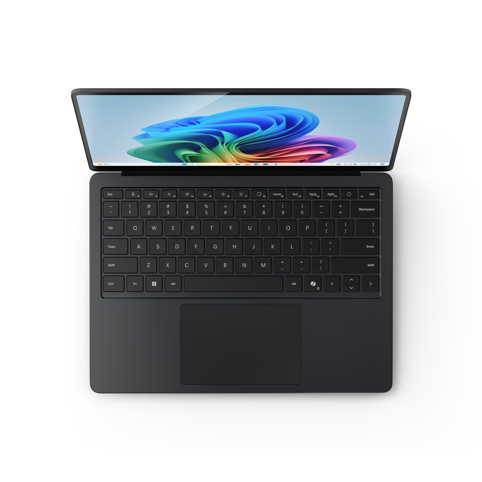 Czarny laptop otwarty na białej powierzchni. Widoczna klawiatura. Widok z góry.