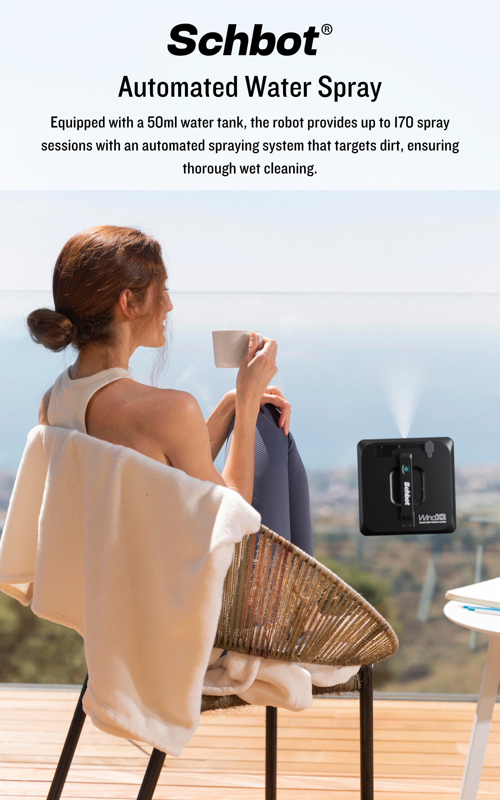 Eine Frau sitzt auf einem Stuhl, hält eine Tasse, während ein Reinigungsroboter Wasser sprüht.