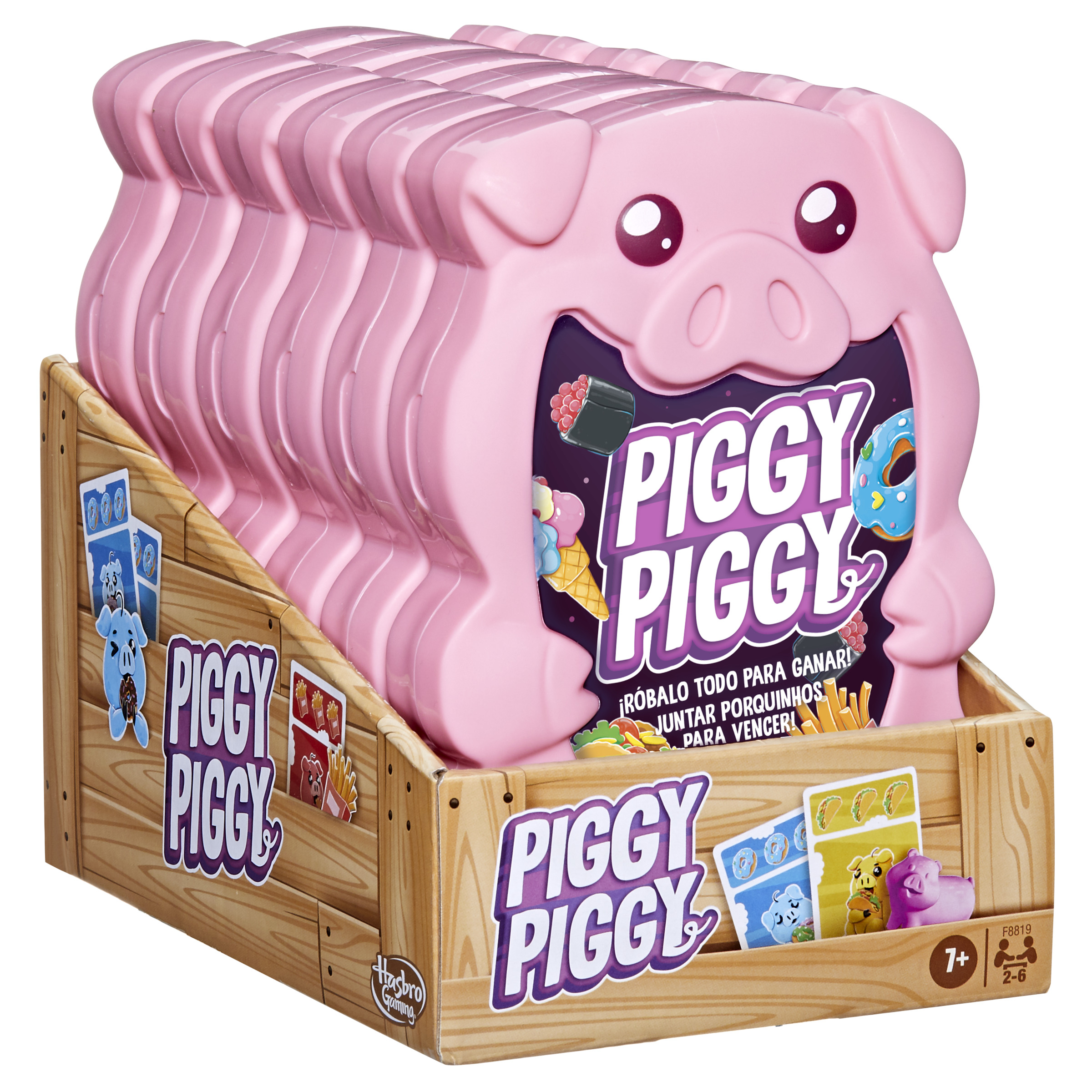 Caja de juego de mesa rosa con forma de cerdo con cartas. La caja está dentro de una caja de madera.