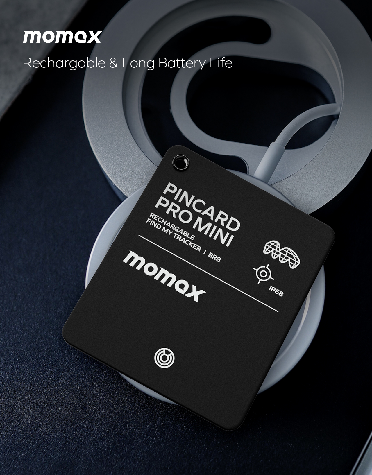Black Momax Pincard Pro Mini tracker on a white wireless charger.