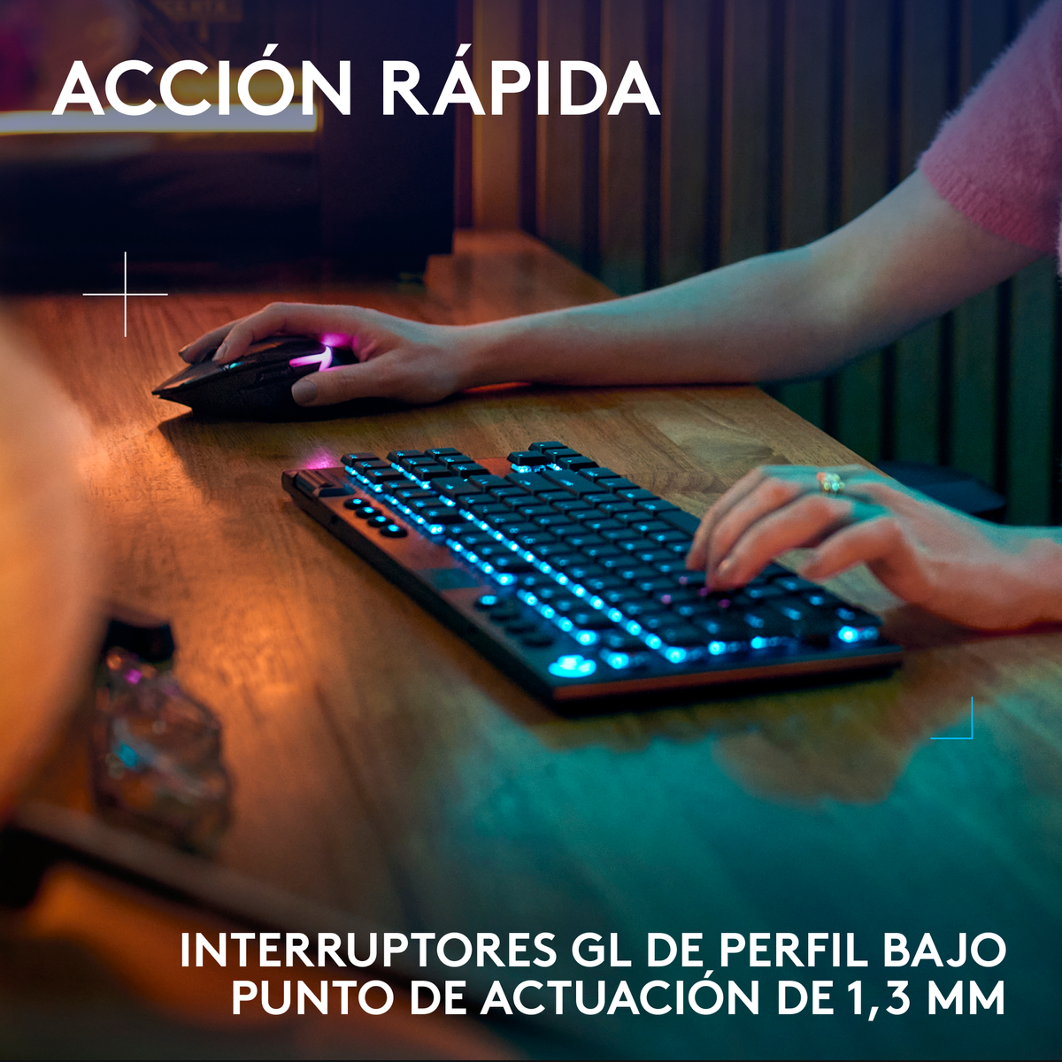 Una persona che usa una tastiera e un mouse da gioco neri su una scrivania di legno con illuminazione RGB.