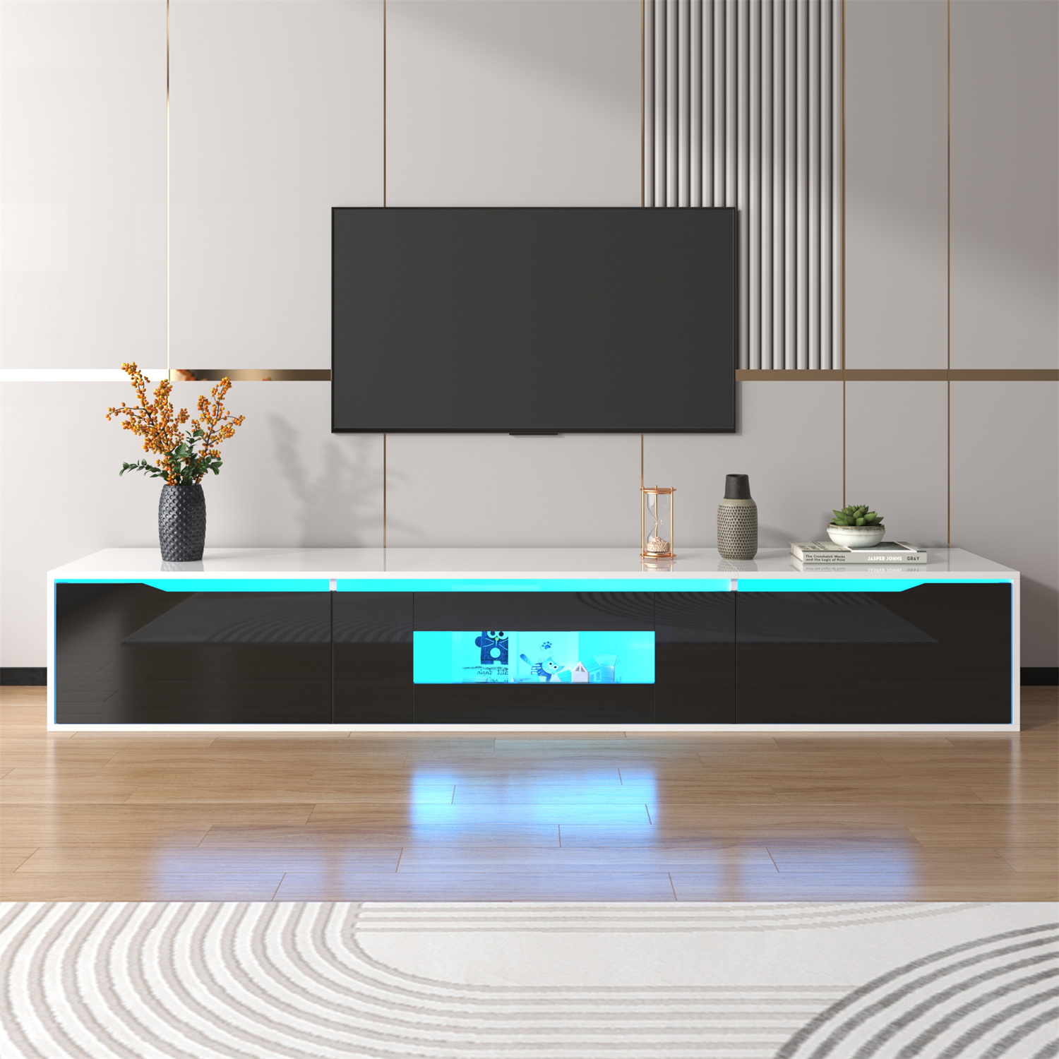 Ein moderner TV-Ständer mit einem Fernseher oben drauf. Der Ständer ist schwarz-weiß mit blauen Lichtern.