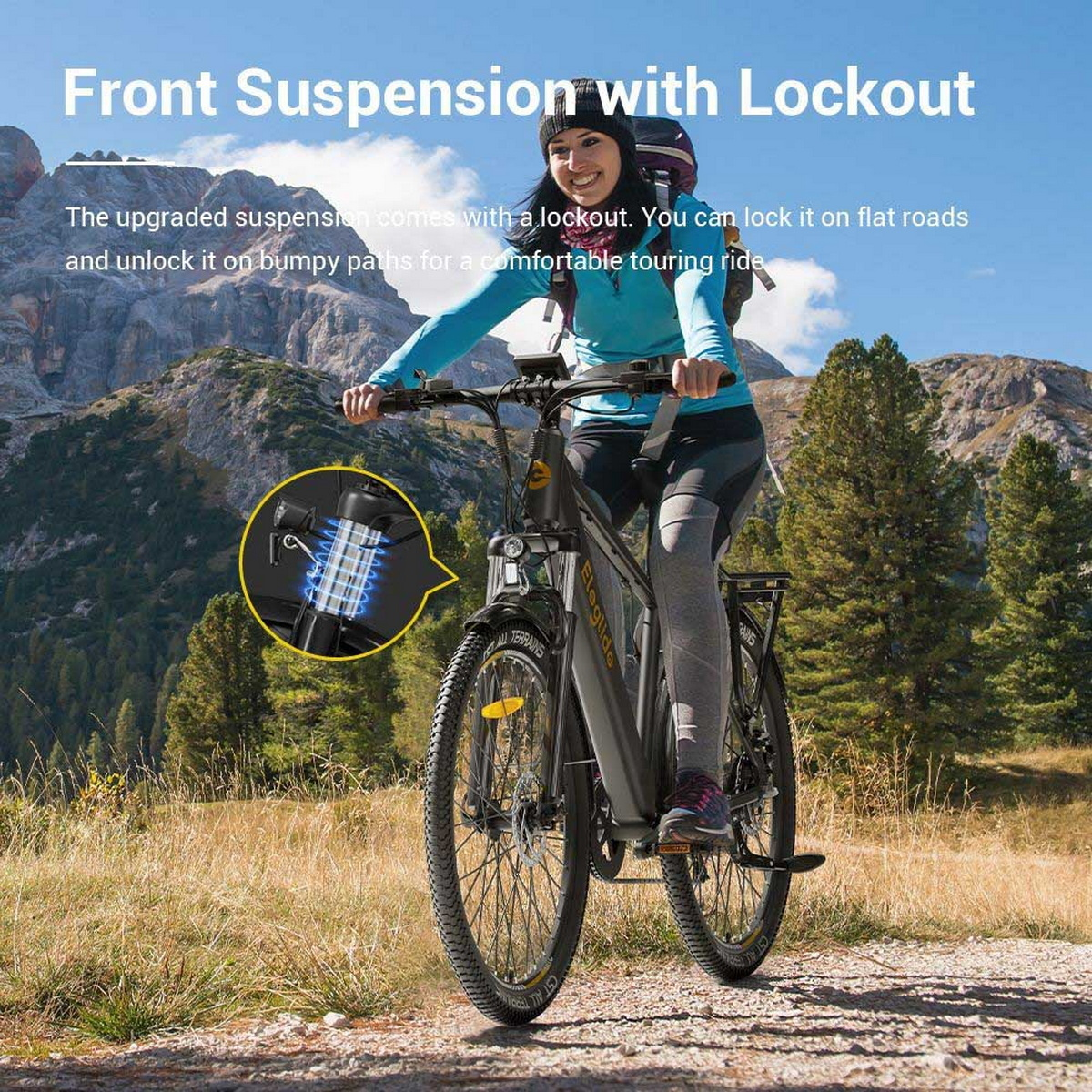 Kobieta jadąca czarnym rowerem elektrycznym na szlaku. W tle widoczny jest łańcuch górski.