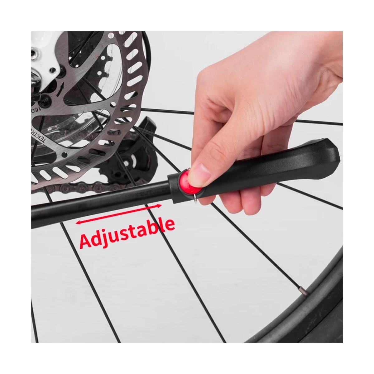 Podpórka rowerowa, z ręką regulującą ją i słowem 'Adjustable'.