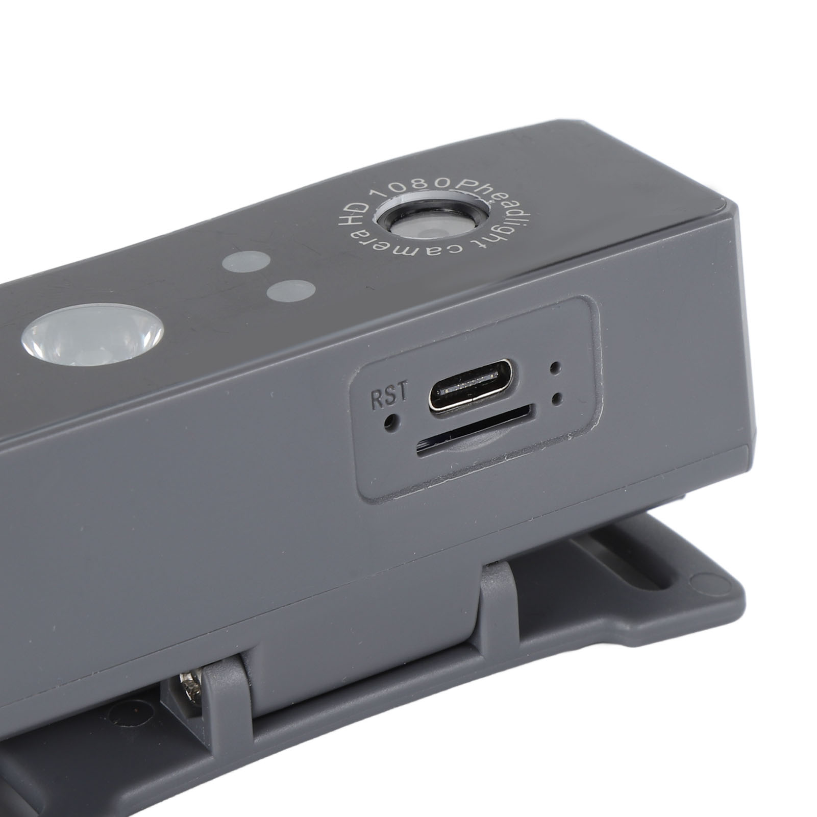 Ein graues Kameragerät mit USB-Anschluss und Steckplatz. Es befindet sich in einer Clip-on-Halterung.