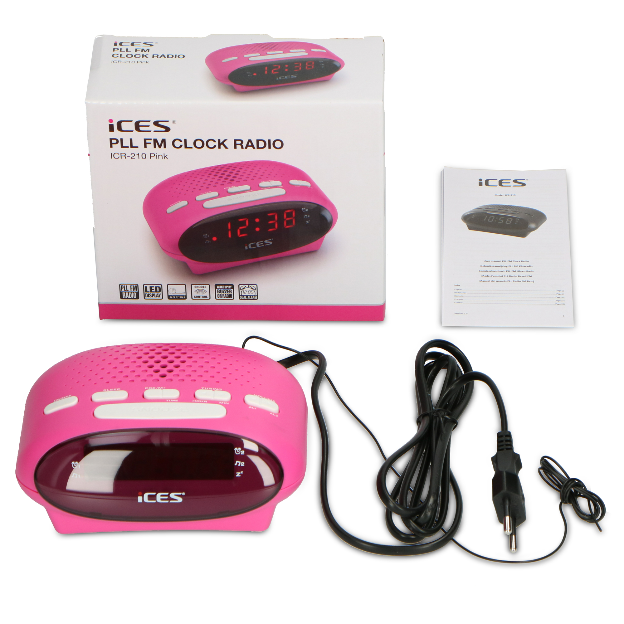 Pink clock radio with box and a manual. Black cable and plug in the foreground.