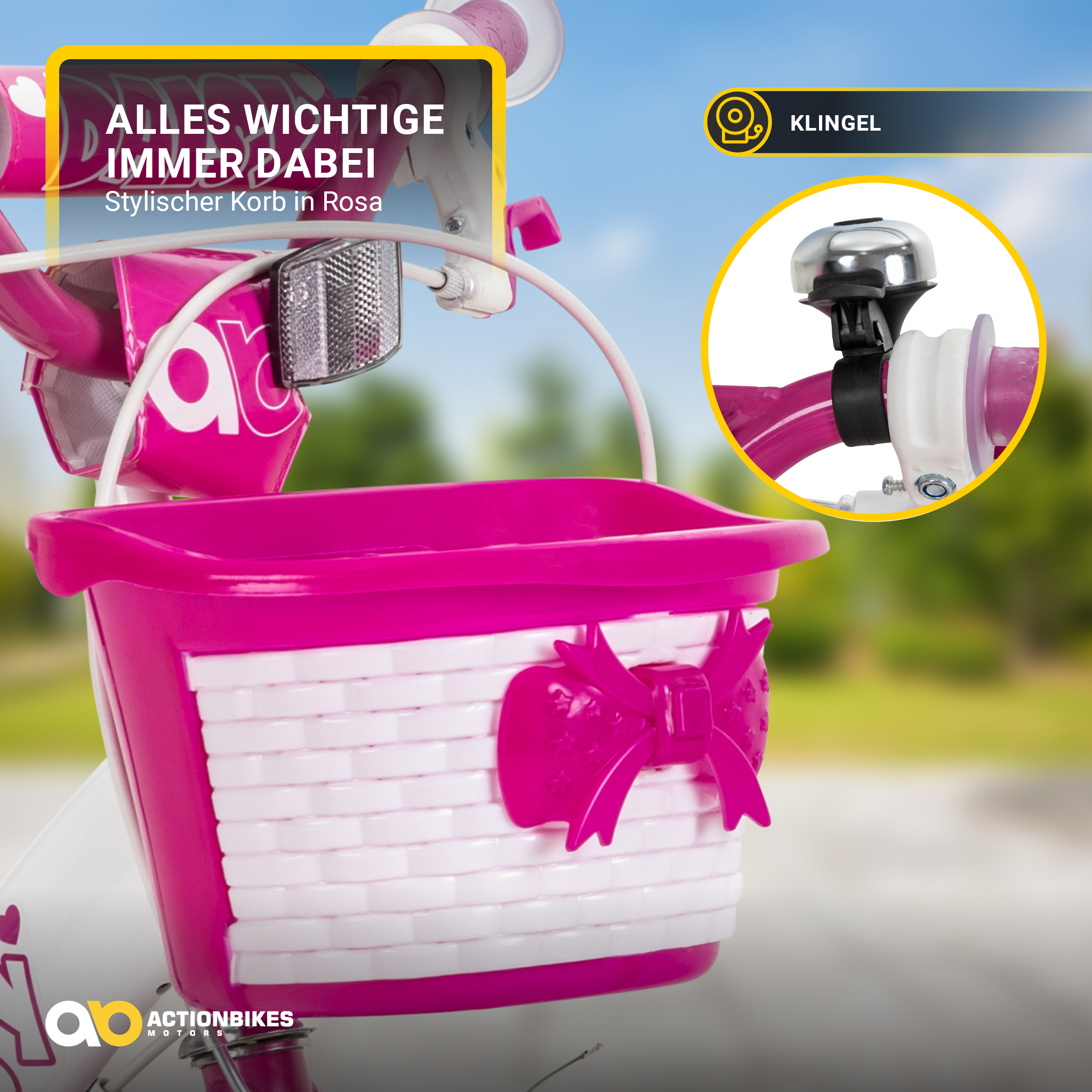 Ein rosa Fahrradkorb mit Schleife, Klingel und Text auf einem Fahrradrahmen, Nahaufnahme.