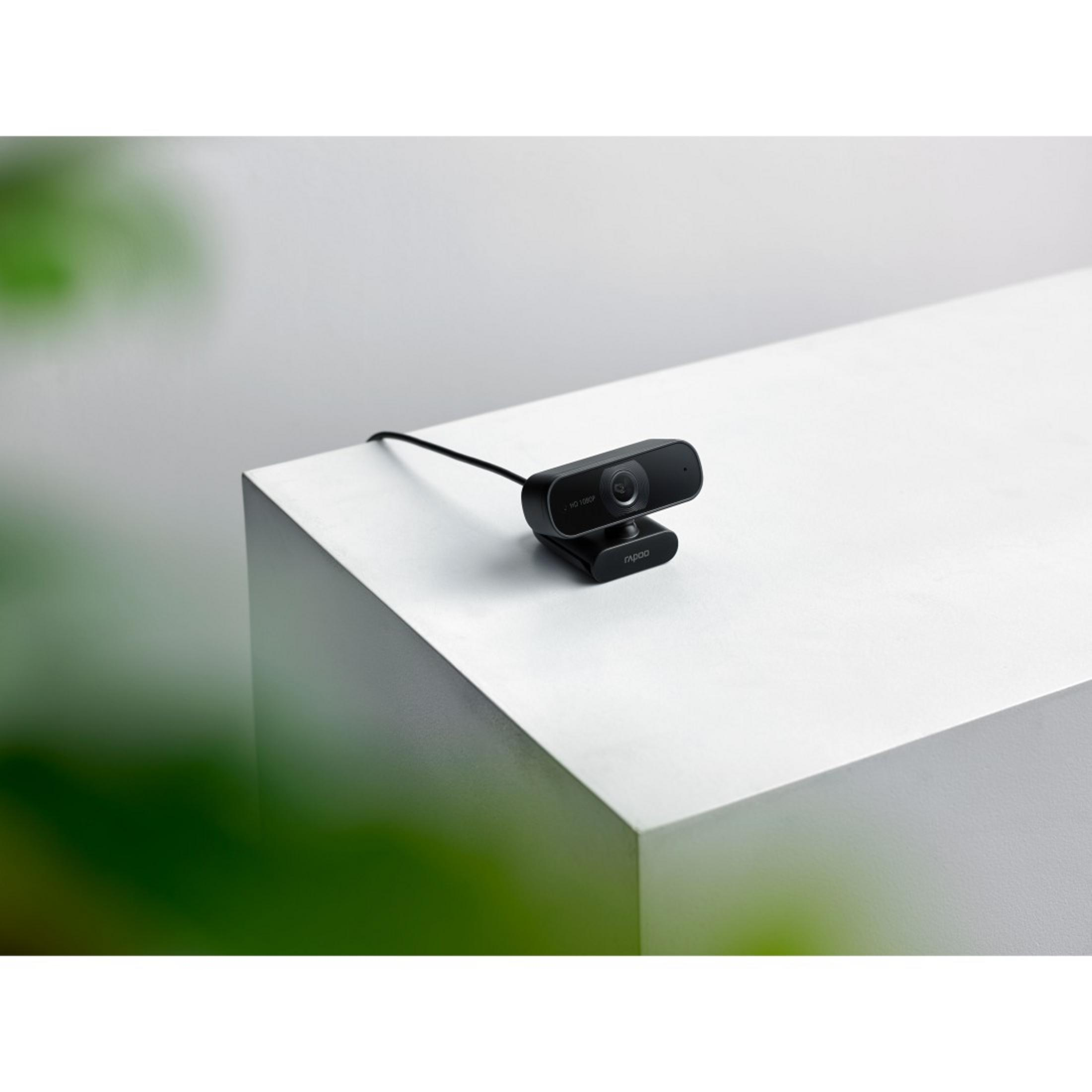 Czarna kamera internetowa na białej kostce. Kamera ma obiektyw i słowo 'nebo'.