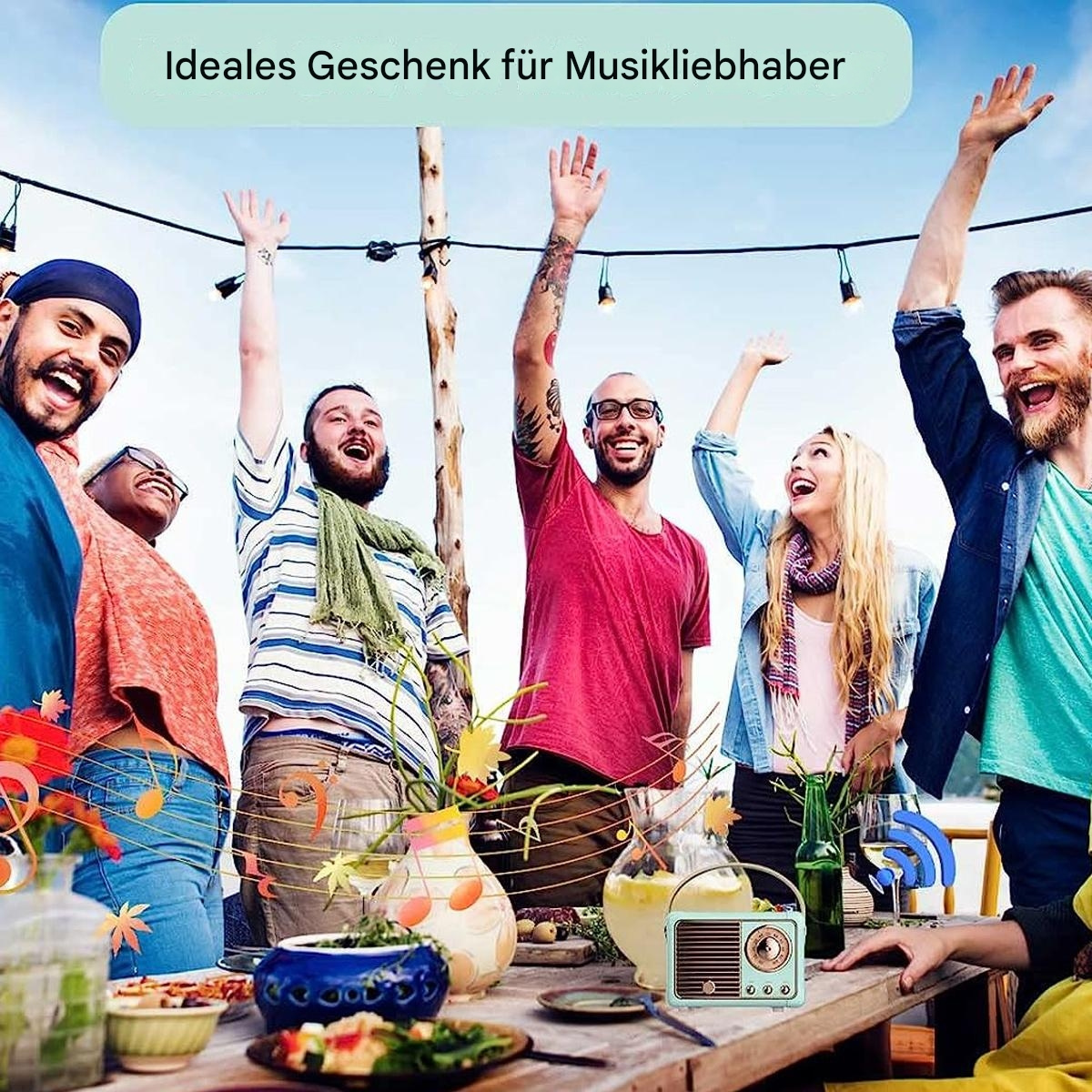 Gruppe von Leuten feiert draußen, mit einem Retro-Radio auf einem Tisch.