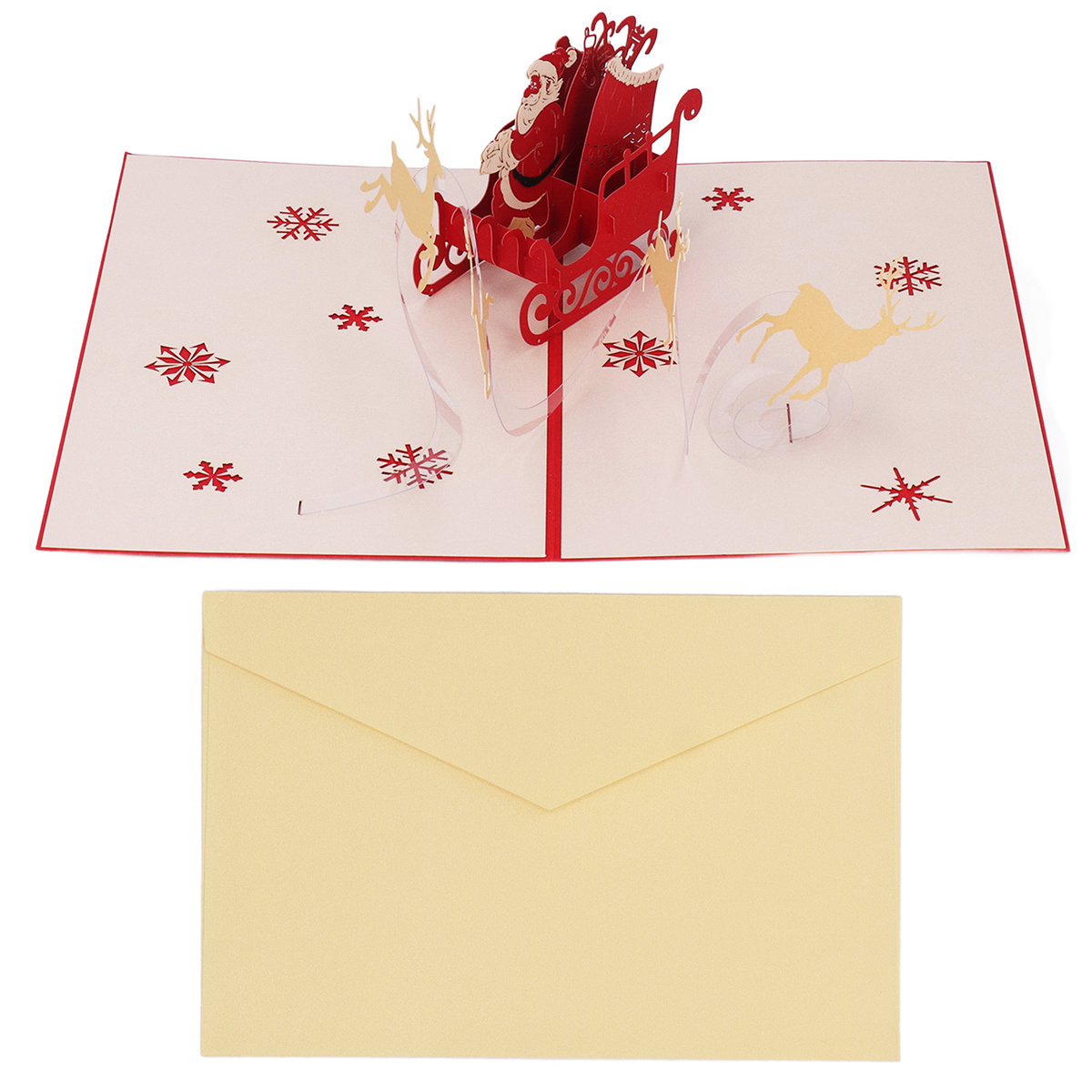 Eine Pop-up-Weihnachtskarte mit einem Weihnachtsmann-Schlitten, Rentieren und Schneeflocken. Ein Umschlag befindet sich unter der Karte.