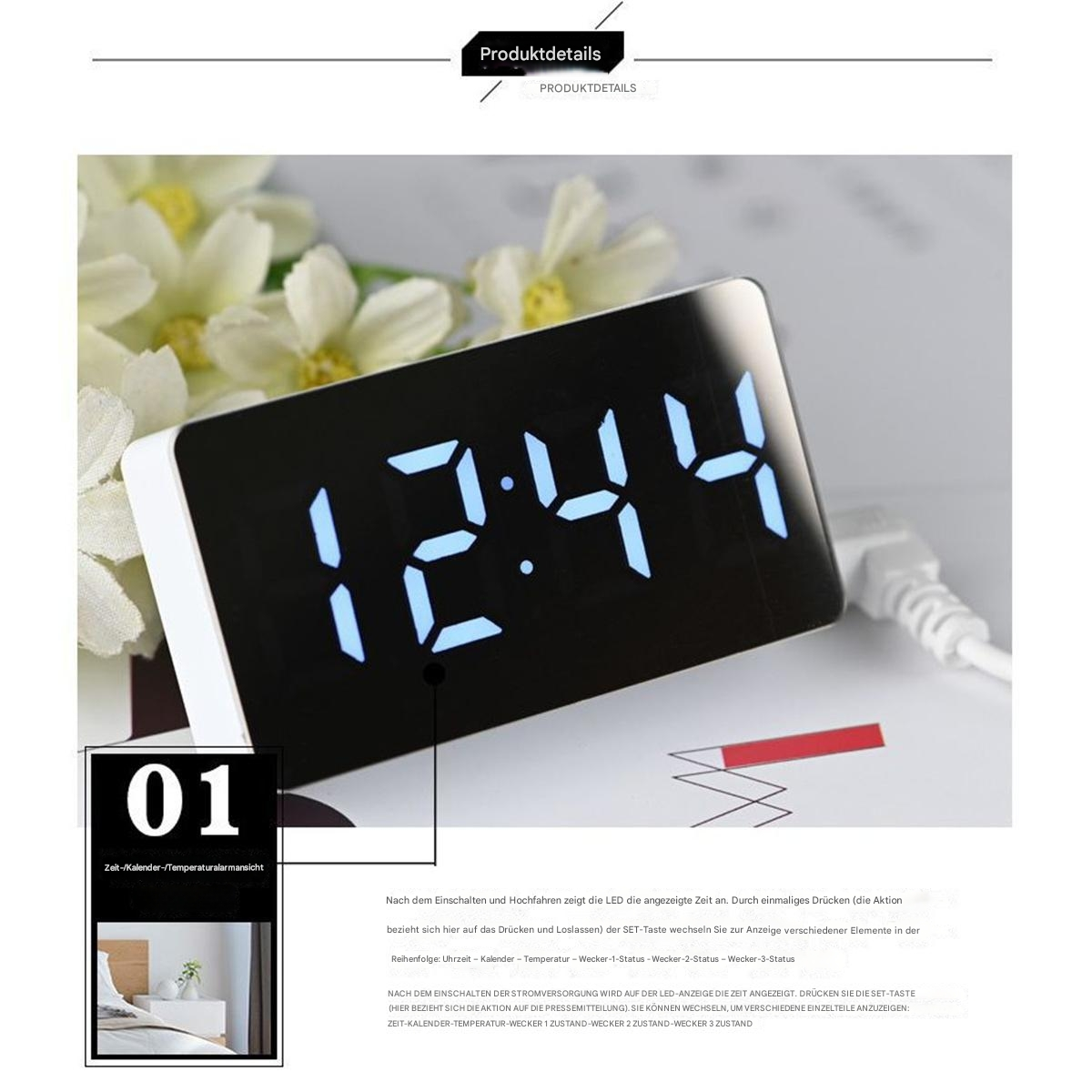 Ein weißer digitaler Wecker mit der Anzeige 12:44, platziert auf einer weißen Oberfläche, mit Blumen im Hintergrund.