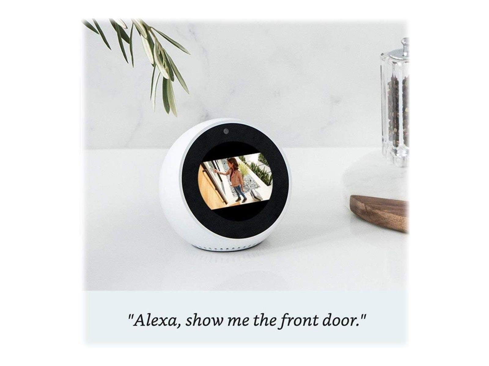 Białe urządzenie smart home z ekranem. Pokazuje osobę. Tekst: 'Alexa, show me the front door'.