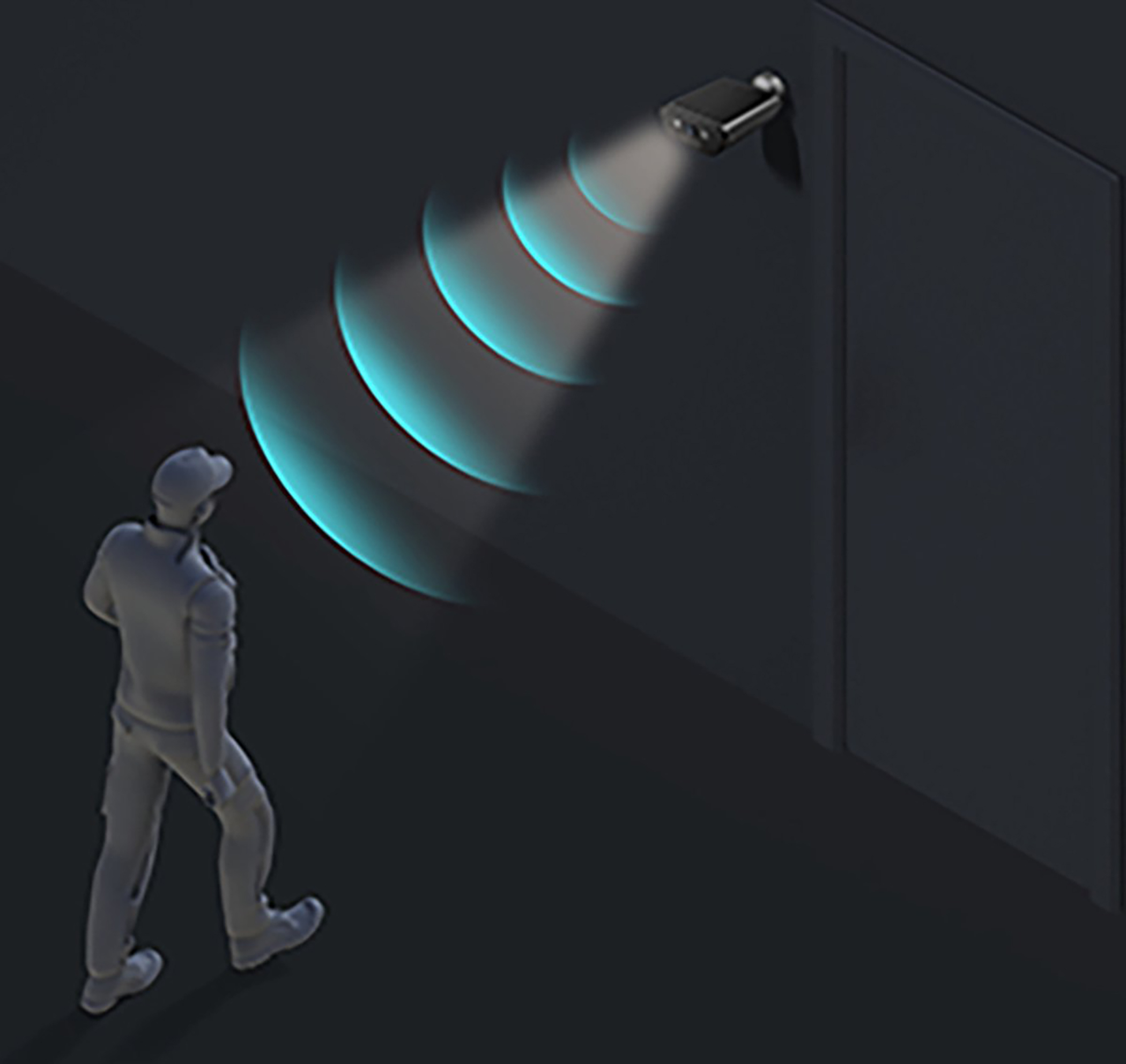 Kamera bezpieczeństwa zamontowana na ciemnej ścianie wykrywająca osobę idącą w ciemnym korytarzu.