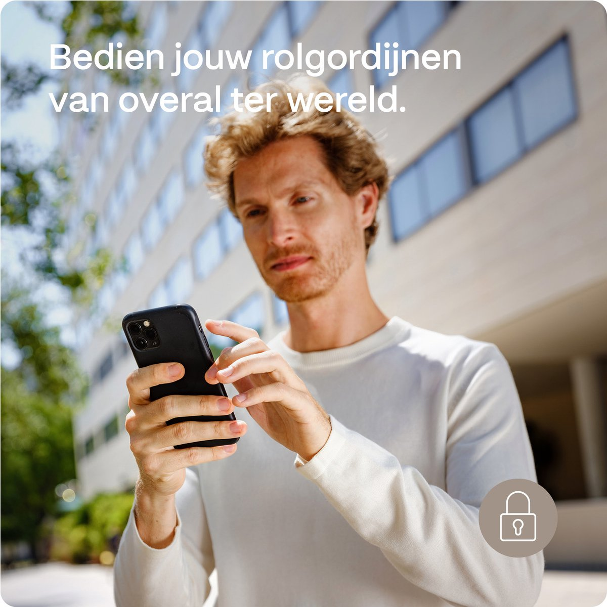 A man holds a phone, looking at it. The text in Dutch reads: Control your blinds from anywhere.
