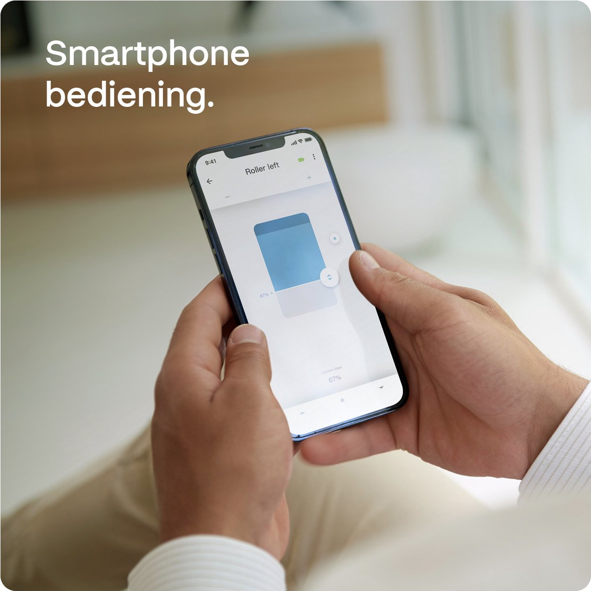 A person holding a smartphone. The phone shows an app interface with a blue bar.