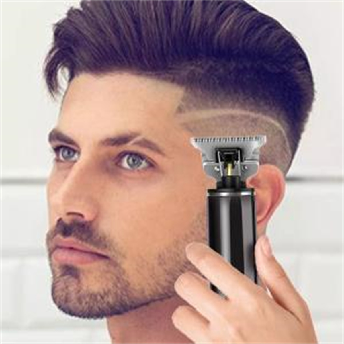 Mann, der sich mit einem Trimmer die Haare schneidet, zeigt ein stilvolles, rasiertes Seitendesign.