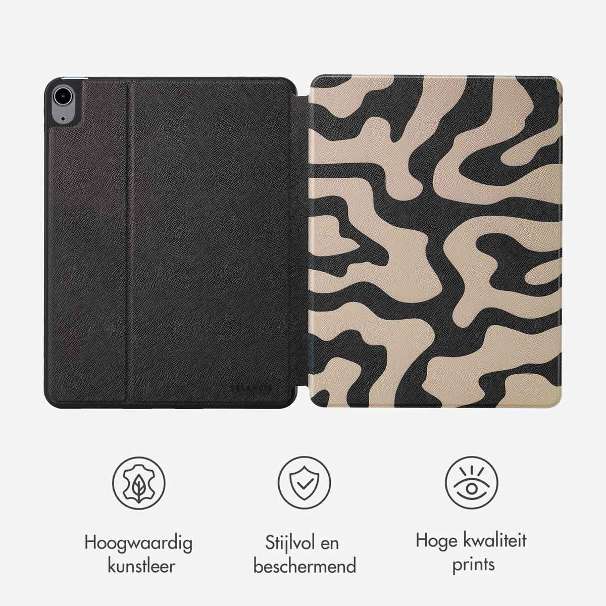Tablet case open showing the inside design of a leopard pattern with a black cover, and a label.