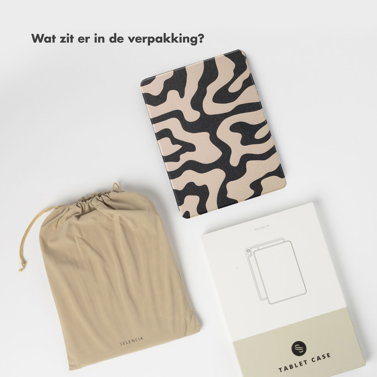 An overhead shot of a tablet case, a drawstring bag, and a box on white.