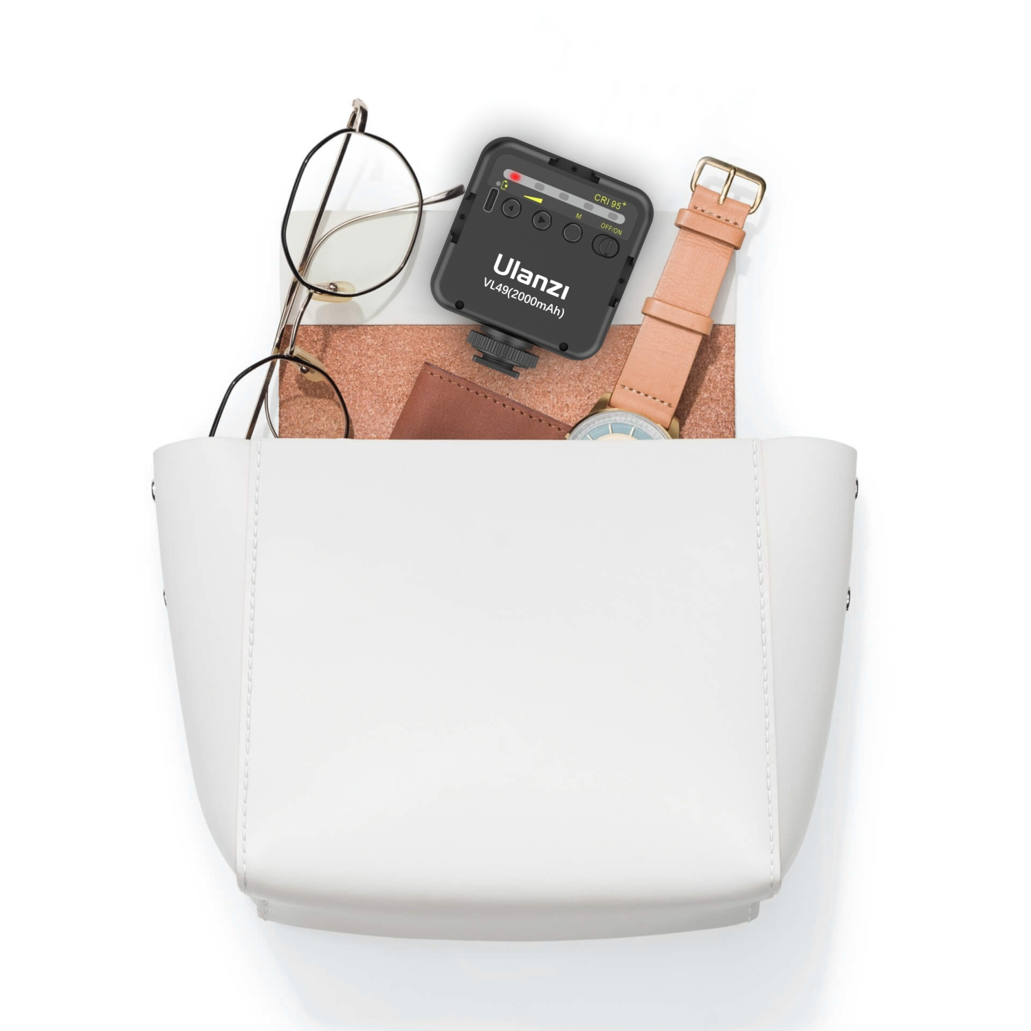 Borsa bianca con oggetti: occhiali, orologio, taccuino, luce Ulanzi VL49. Contenuto visibile.
