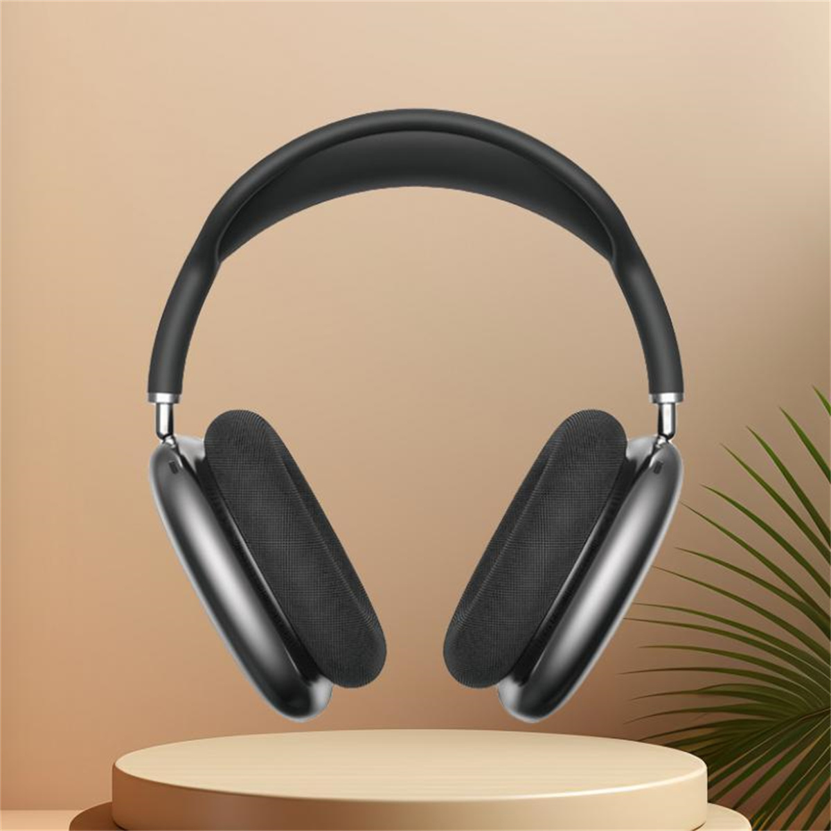 Schwarze Apple AirPods Max Kopfhörer auf einem beigen Podest. Der Hintergrund ist ebenfalls beige mit einer grünen Pflanze.