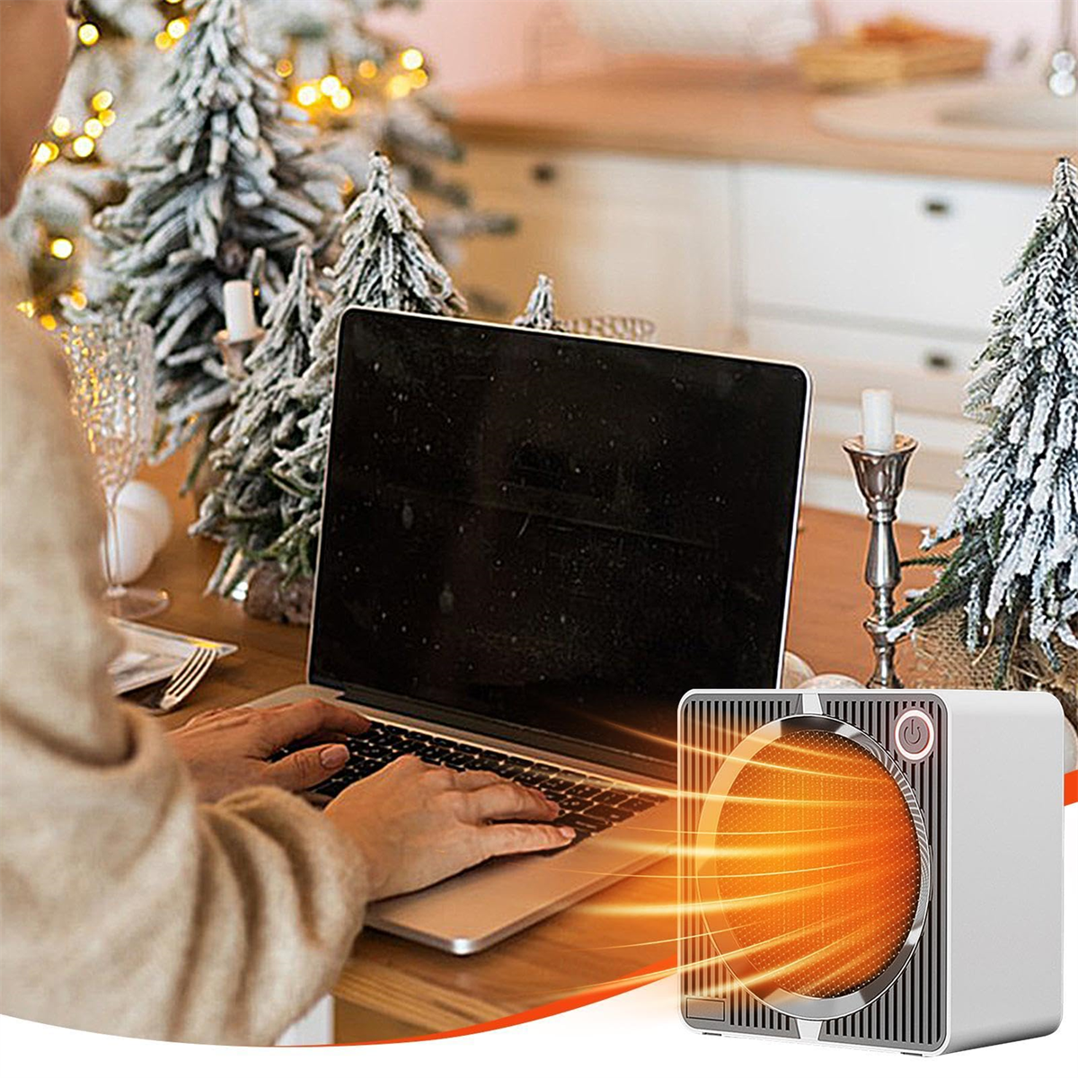 Person verwendet Laptop in der Nähe eines Heizgeräts mit orangefarbenem Element.