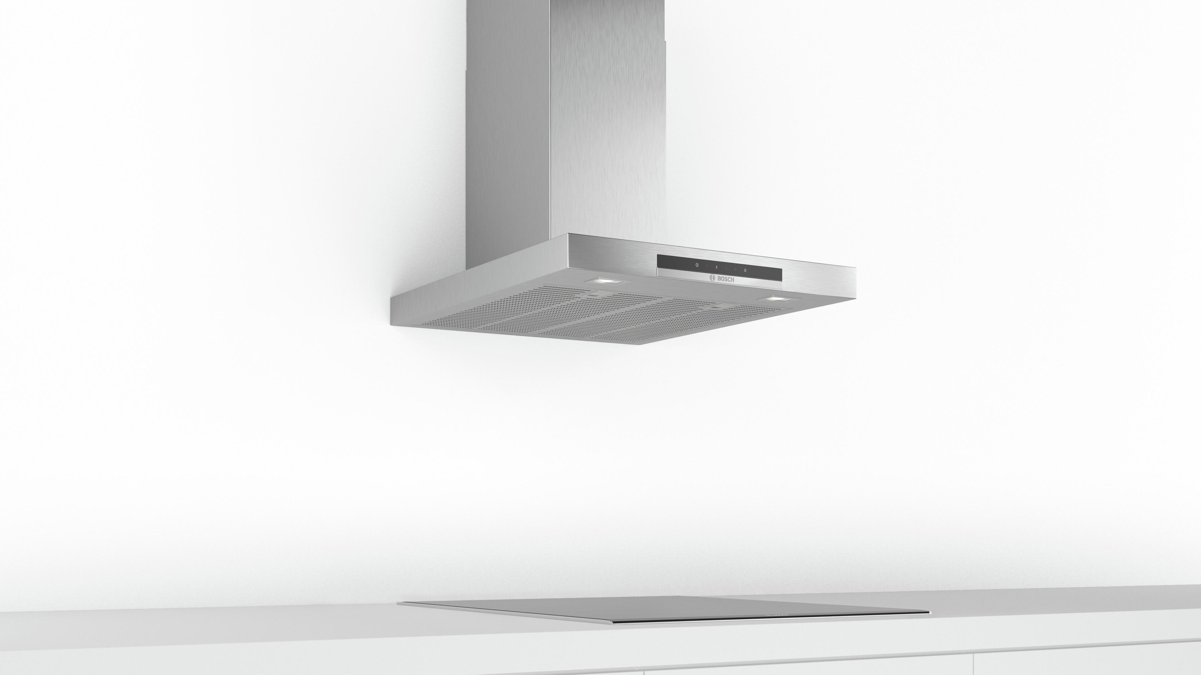 Cappa da cucina moderna, acciaio inox, su piano di lavoro bianco.