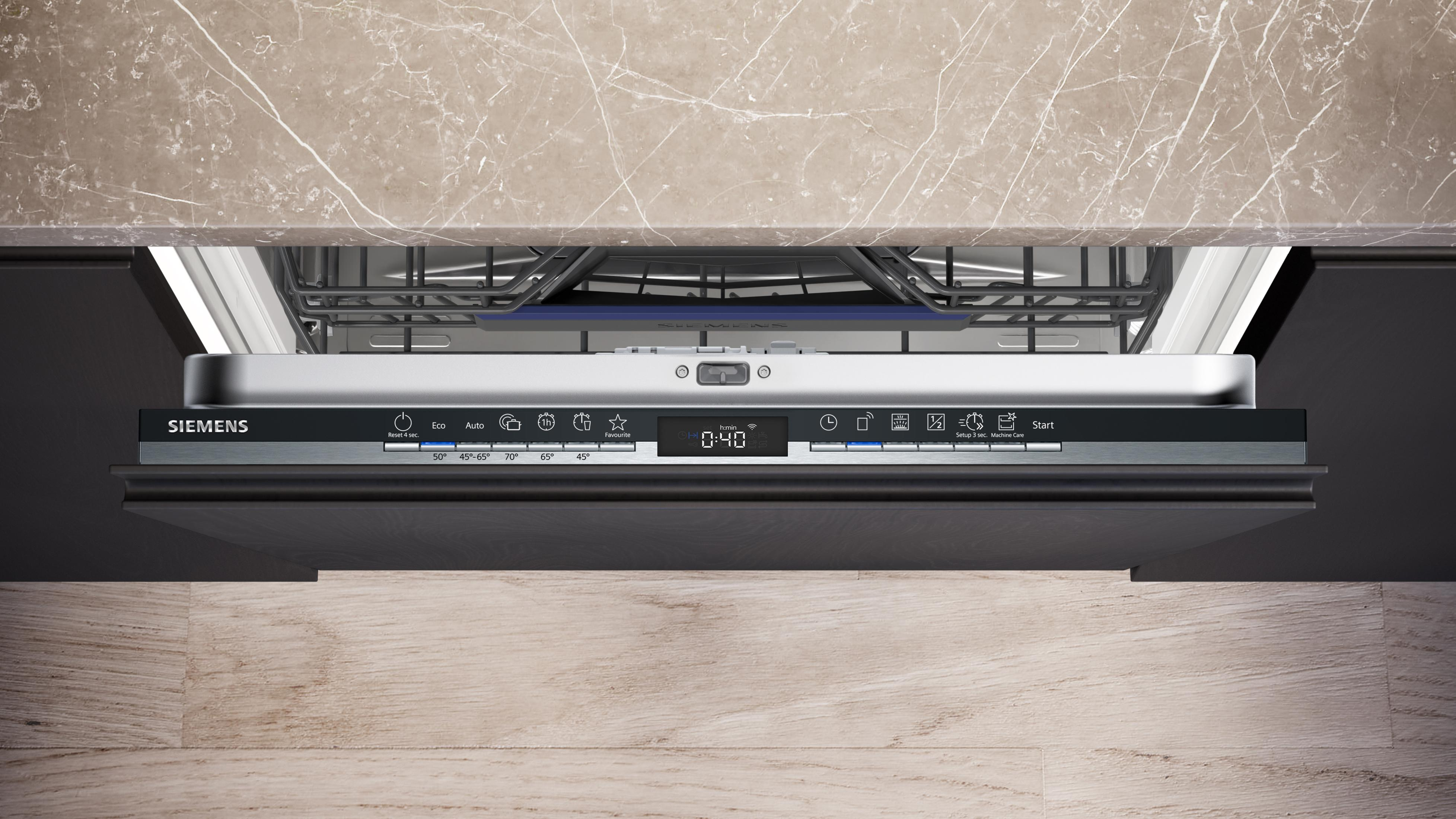 Ein Geschirrspüler mit geöffneter Tür, der Bedienelemente und das Innere zeigt. Die Oberfläche ist Marmor.