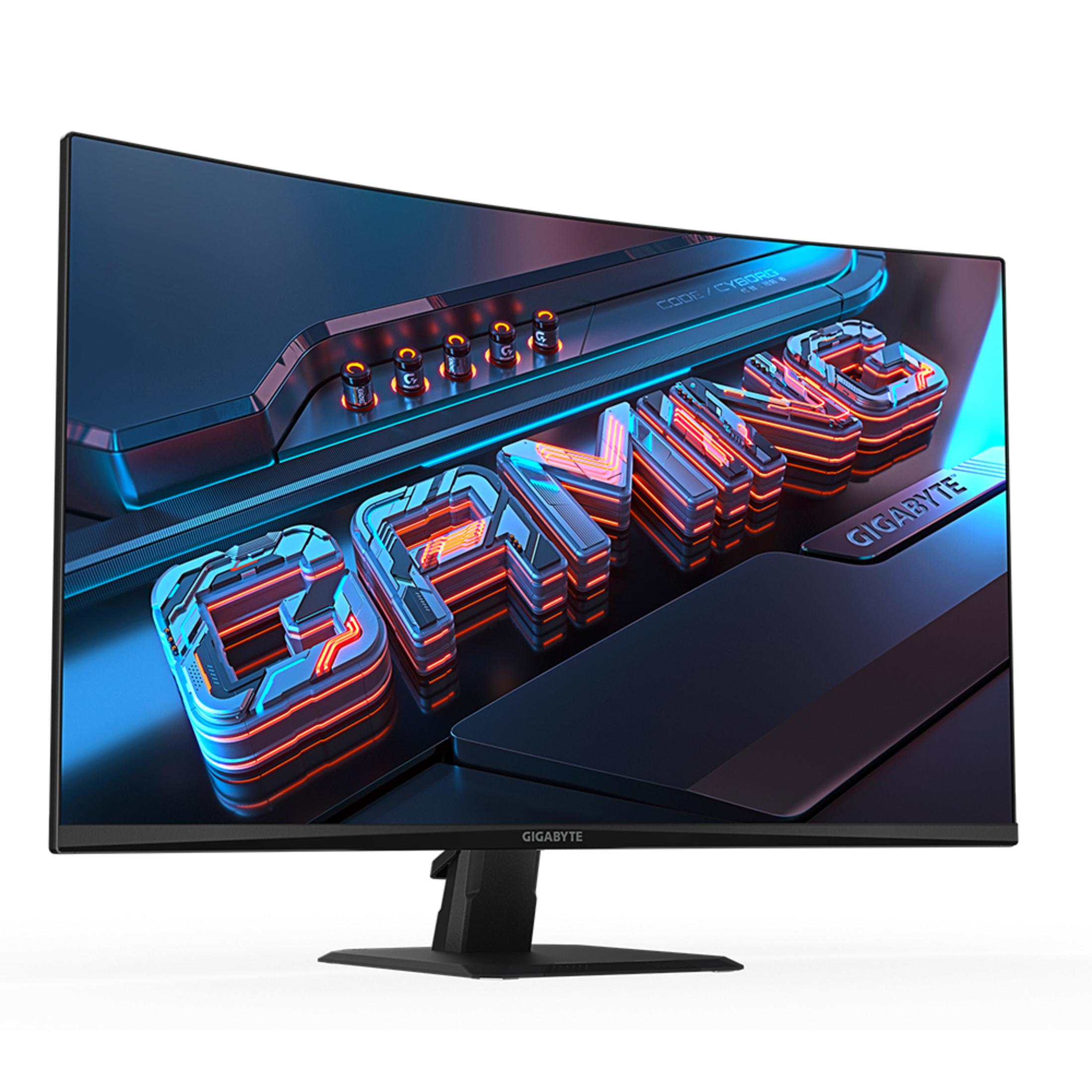 Monitor curvo da gioco con 'GAMING' in rosso/blu. Cornice, supporto e scrivania neri.
