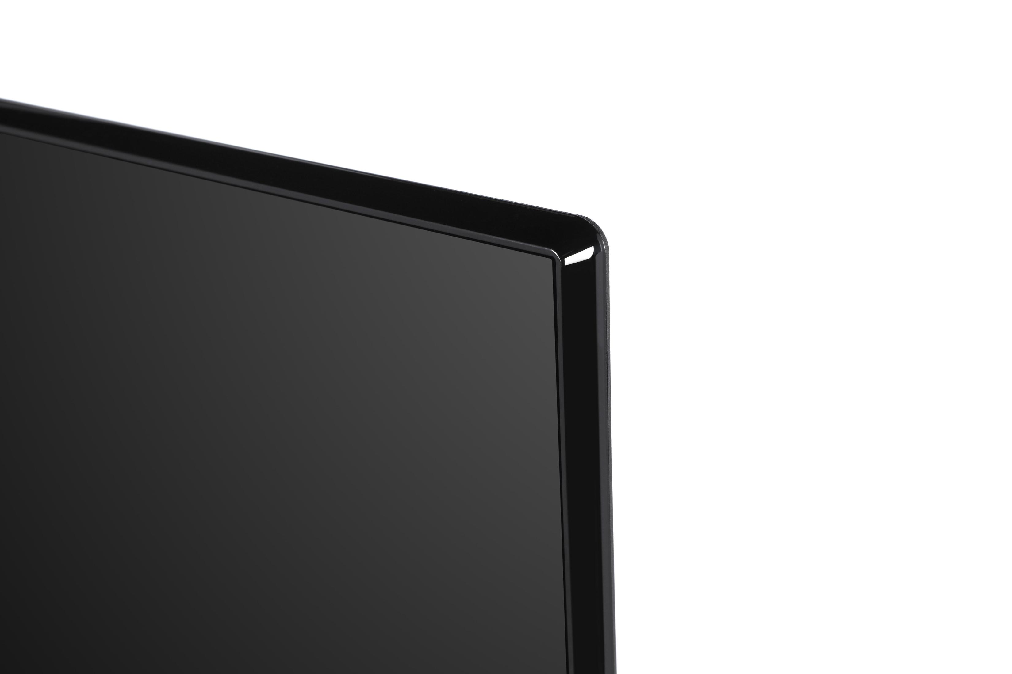 Zbliżenie czarnego rogu monitora, pokazujące gładkie, błyszczące wykończenie na białym tle.