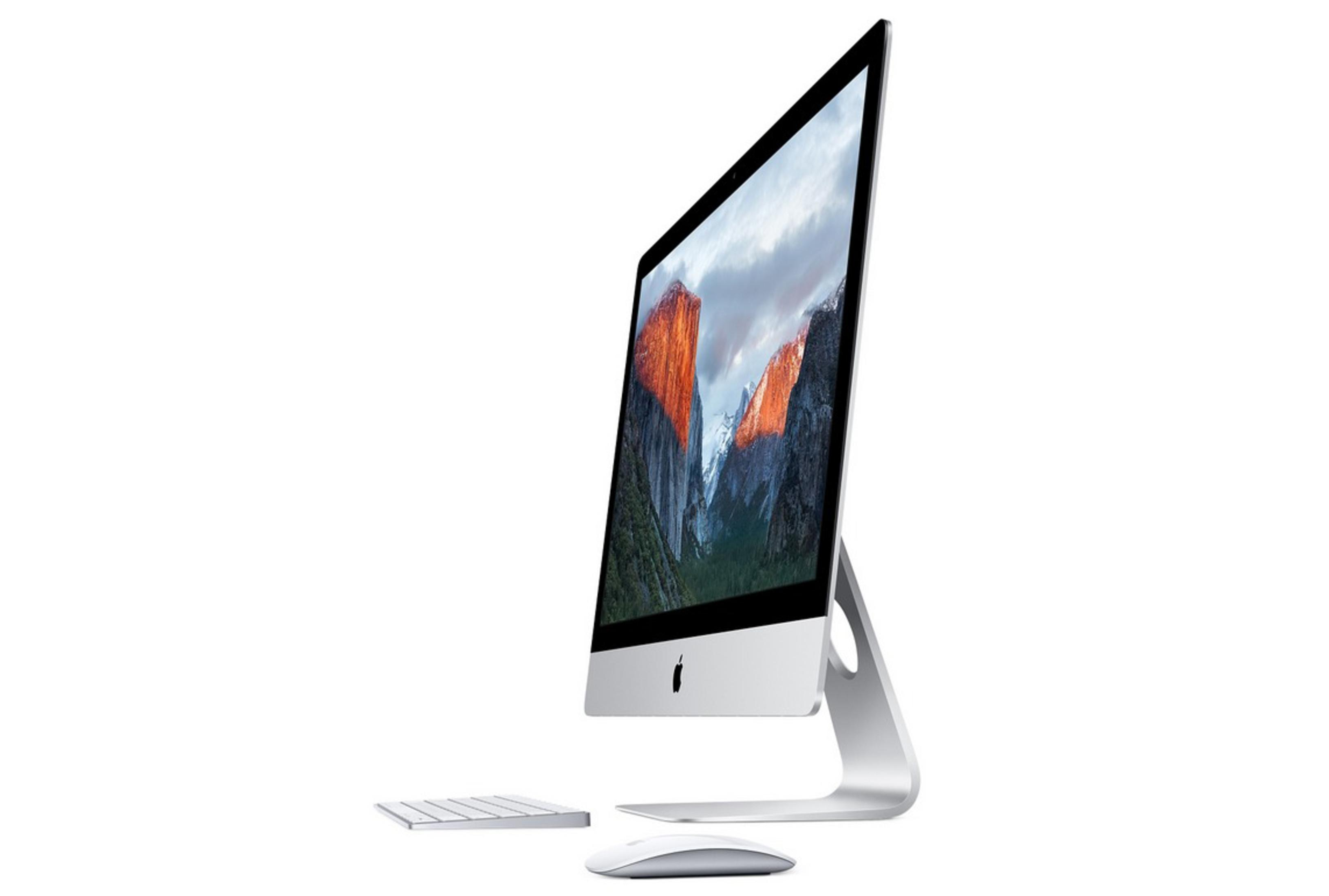Komputer iMac. Jest srebrny z czarnym ekranem, który wyświetla krajobraz górski.