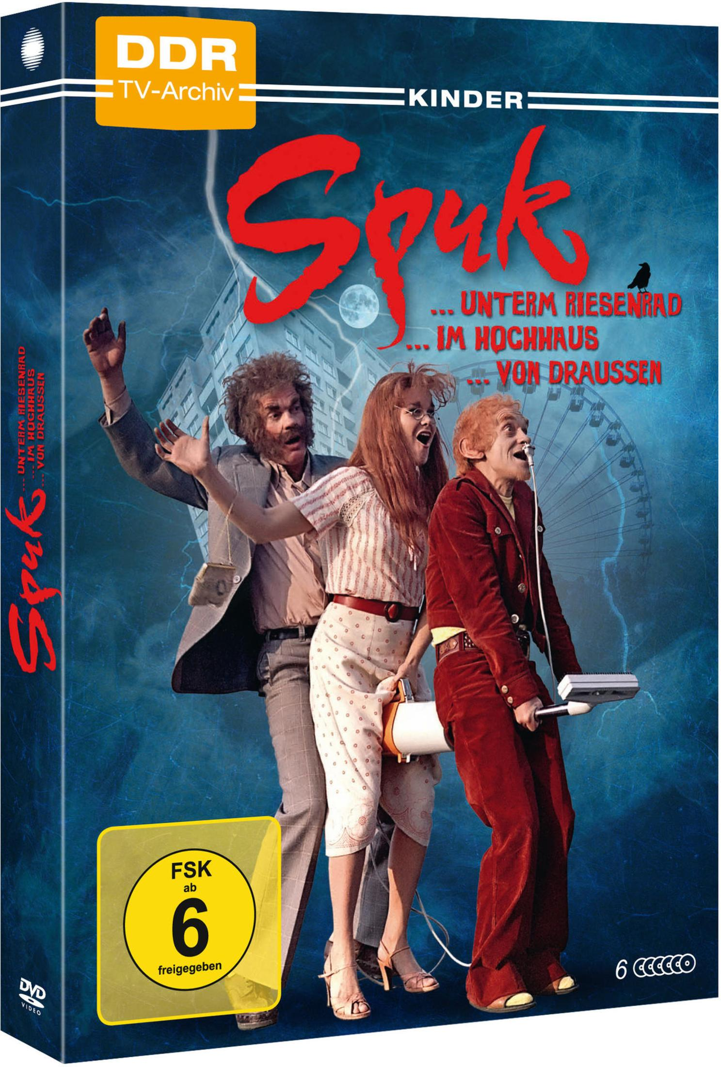 DVD-Cover von Spuk mit drei verkleideten Personen auf blauem Hintergrund mit Hochhaus und Riesenrad.