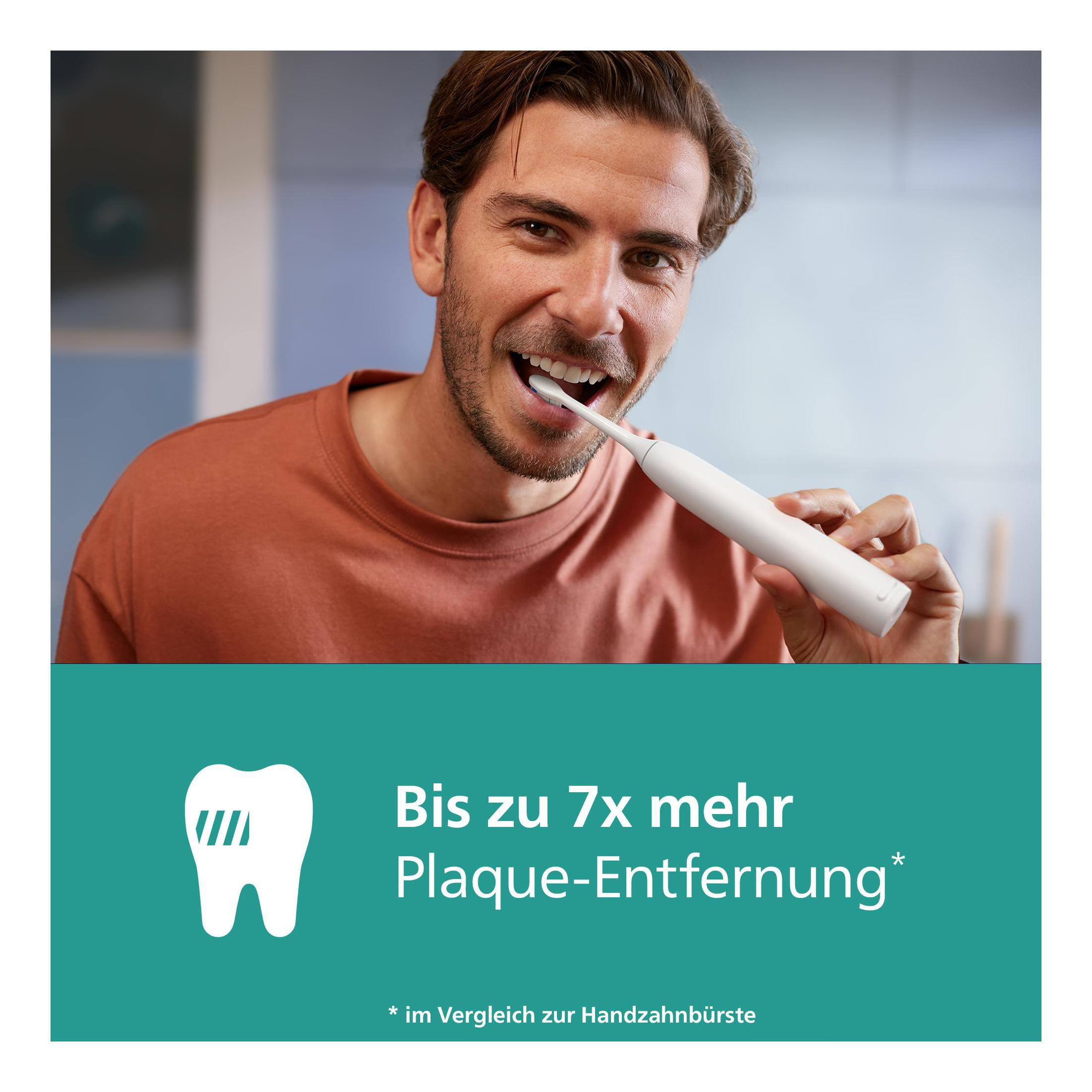 Mężczyzna myjący zęby białą elektryczną szczoteczką. Reklama produktu poniżej.