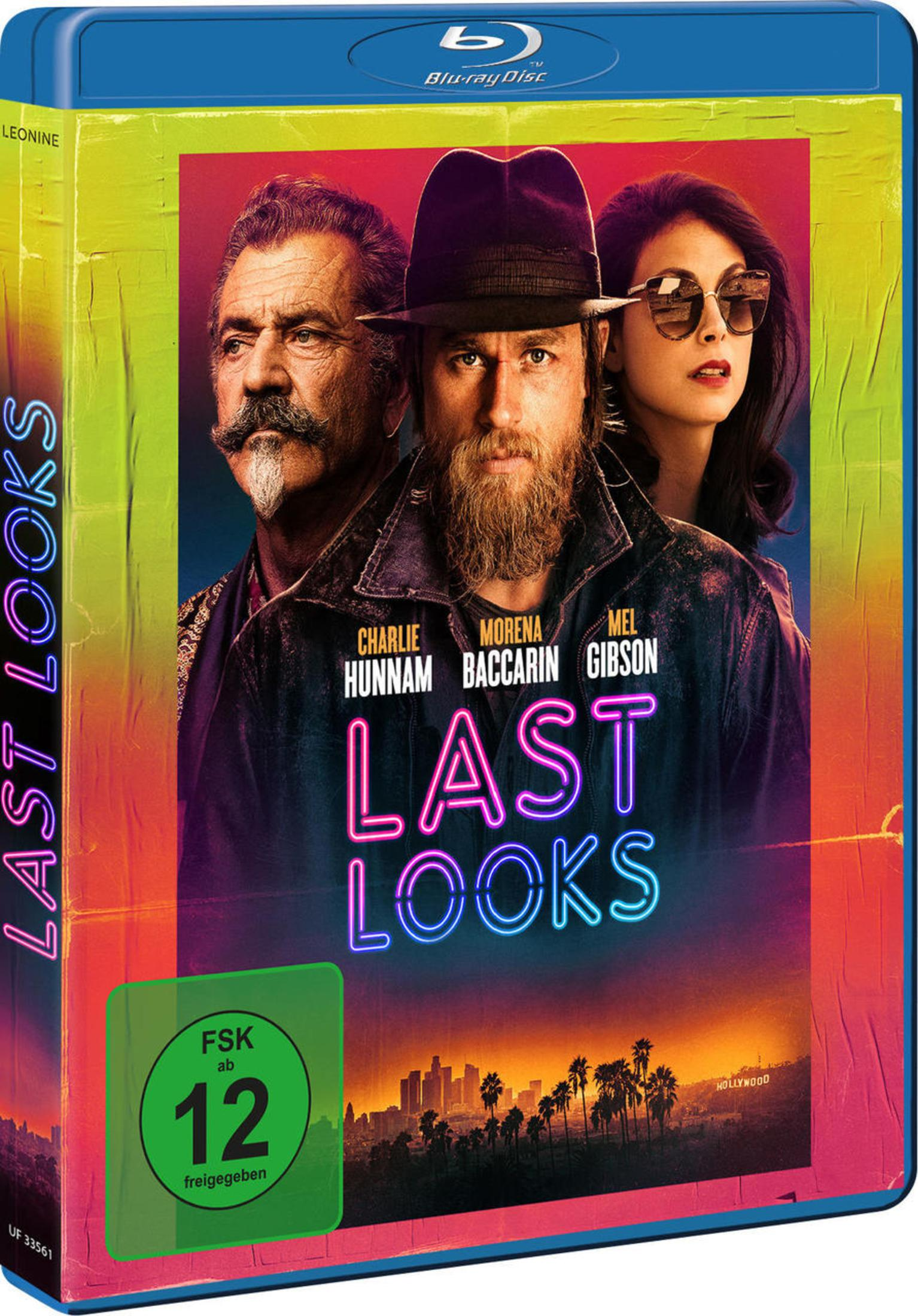 Blu-ray Cover von Last Looks mit Charlie Hunnam, Morena Baccarin und Mel Gibson vor einer bunten Kulisse.