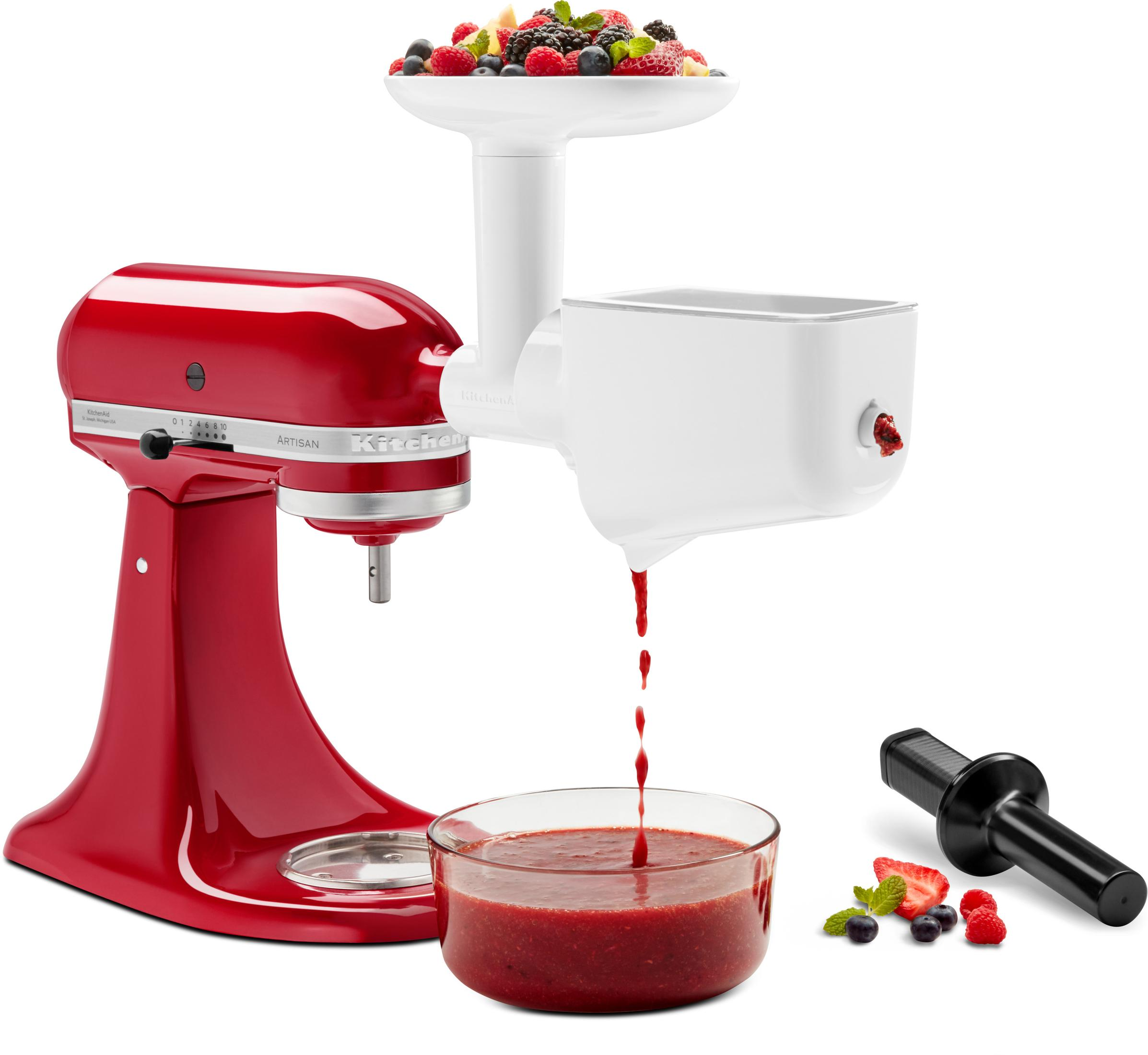 Mixer KitchenAid rosso con accessorio, ciotola di frutta e succo.