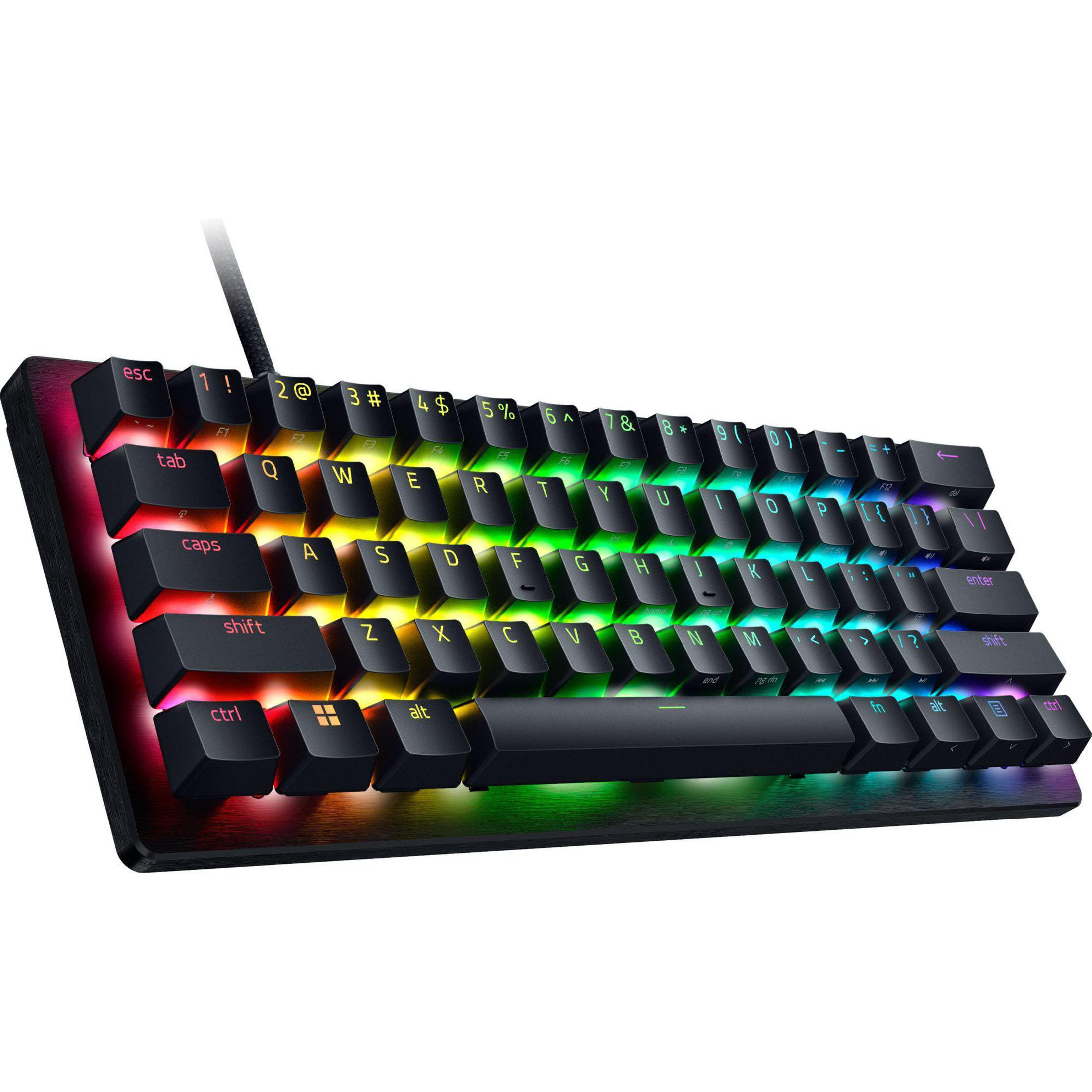 Eine schwarze, beleuchtete Tastatur mit regenbogenfarbenen Tasten. Die Tastatur liegt auf einer weißen Oberfläche.