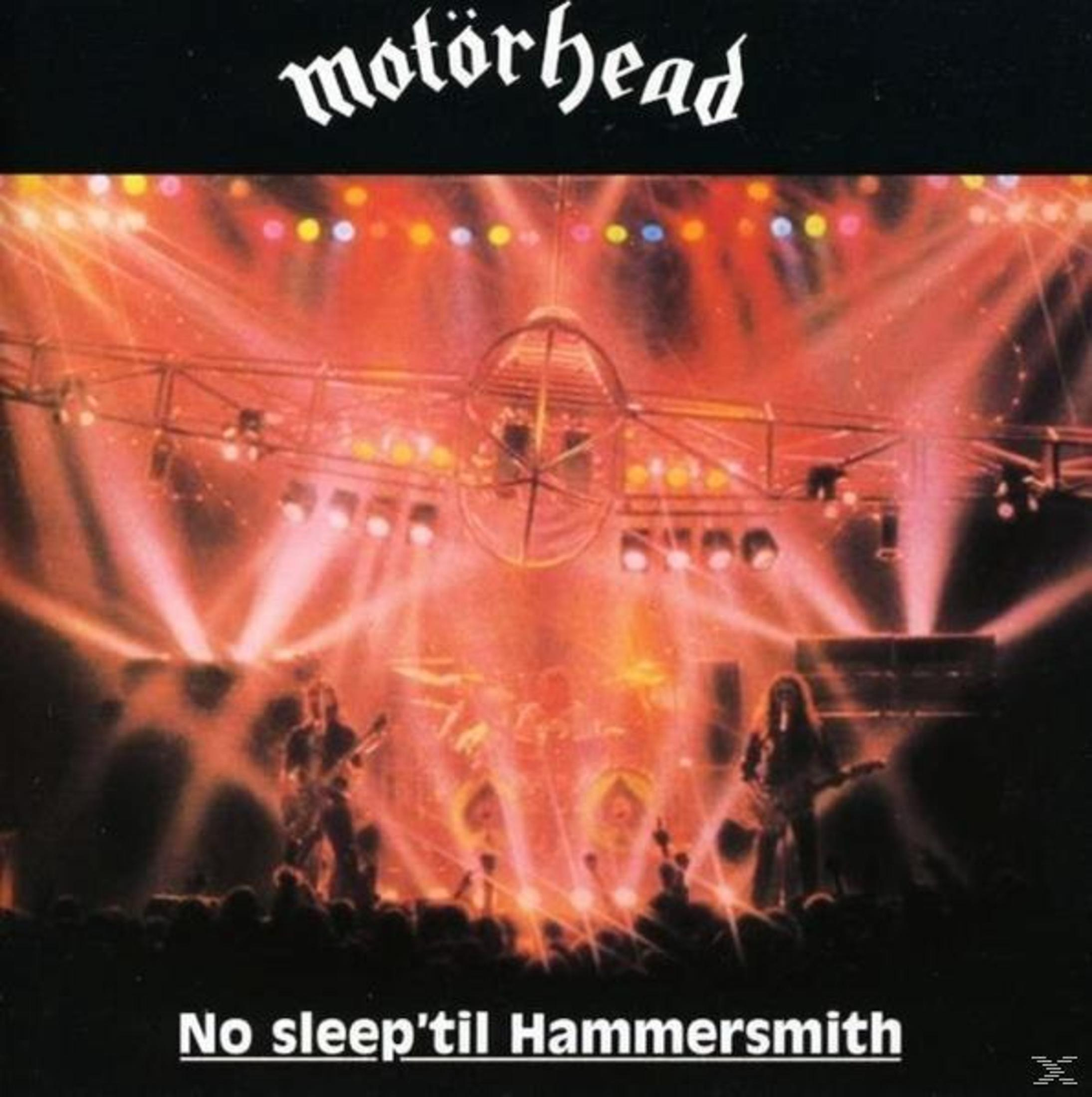 Pochette de l'album de Motörhead, concert live. Les lumières de la scène et les membres du groupe sont visibles.