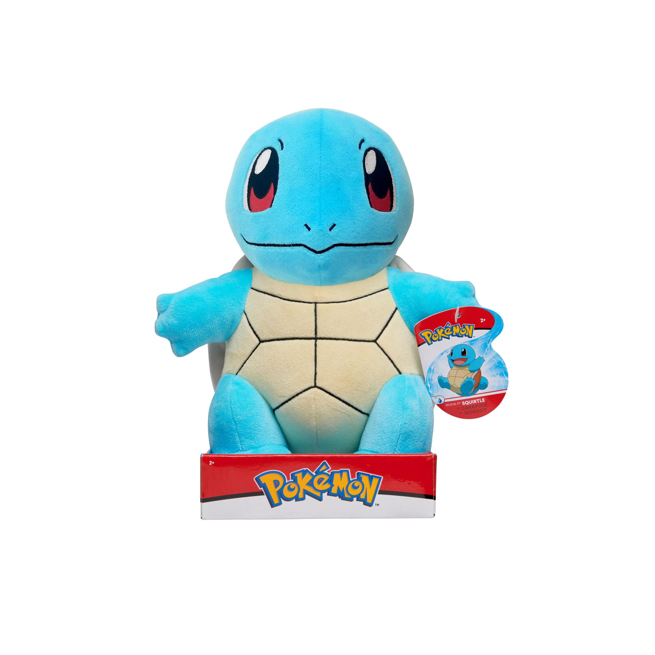 Ein Squirtle-Plüschtier, blau mit cremefarbenem Bauch, auf einer rot-weißen Pokemon-Box.