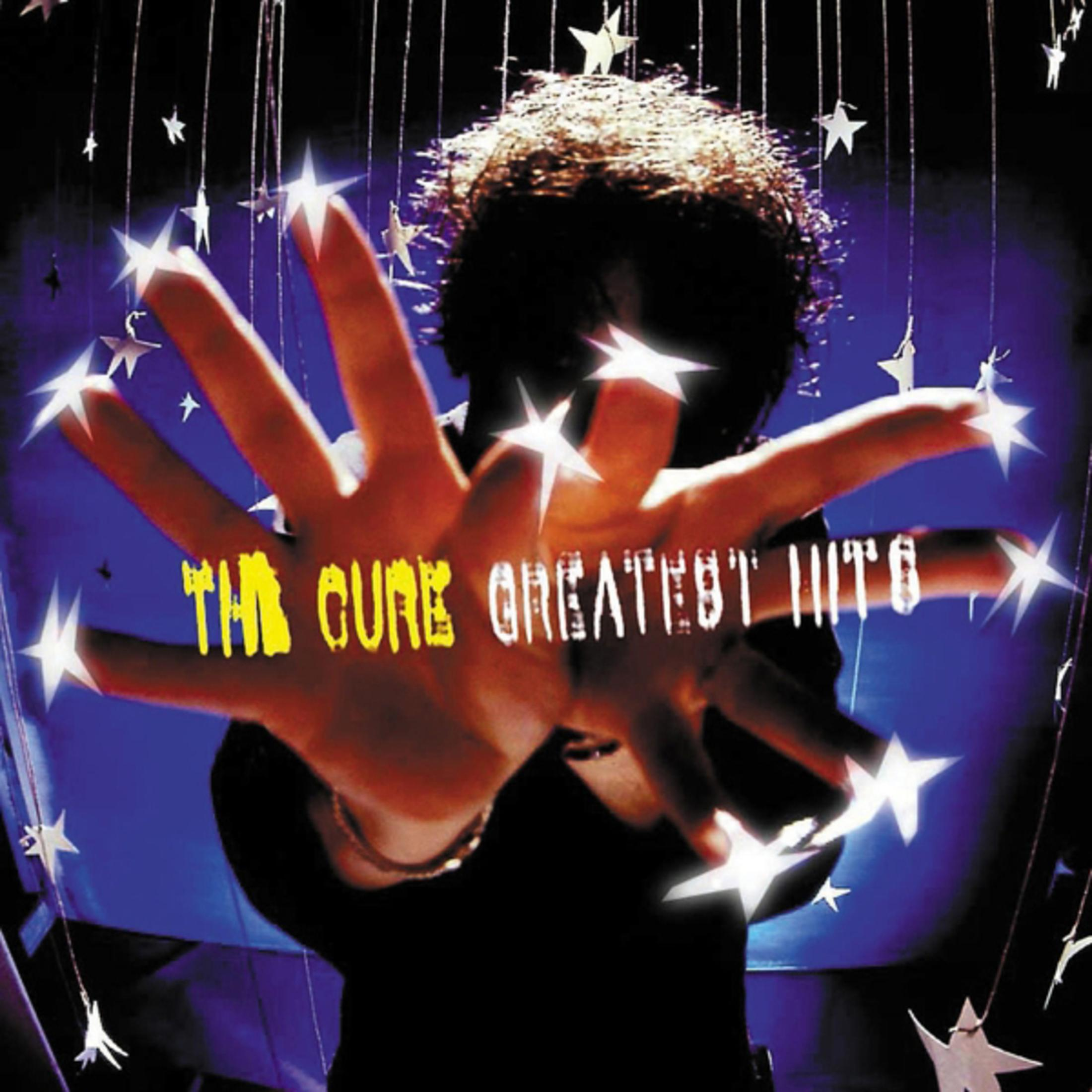 Okładka albumu z dłonią wyciągniętą w kierunku widza, z napisem 'THE CURE GREATEST HITS'.