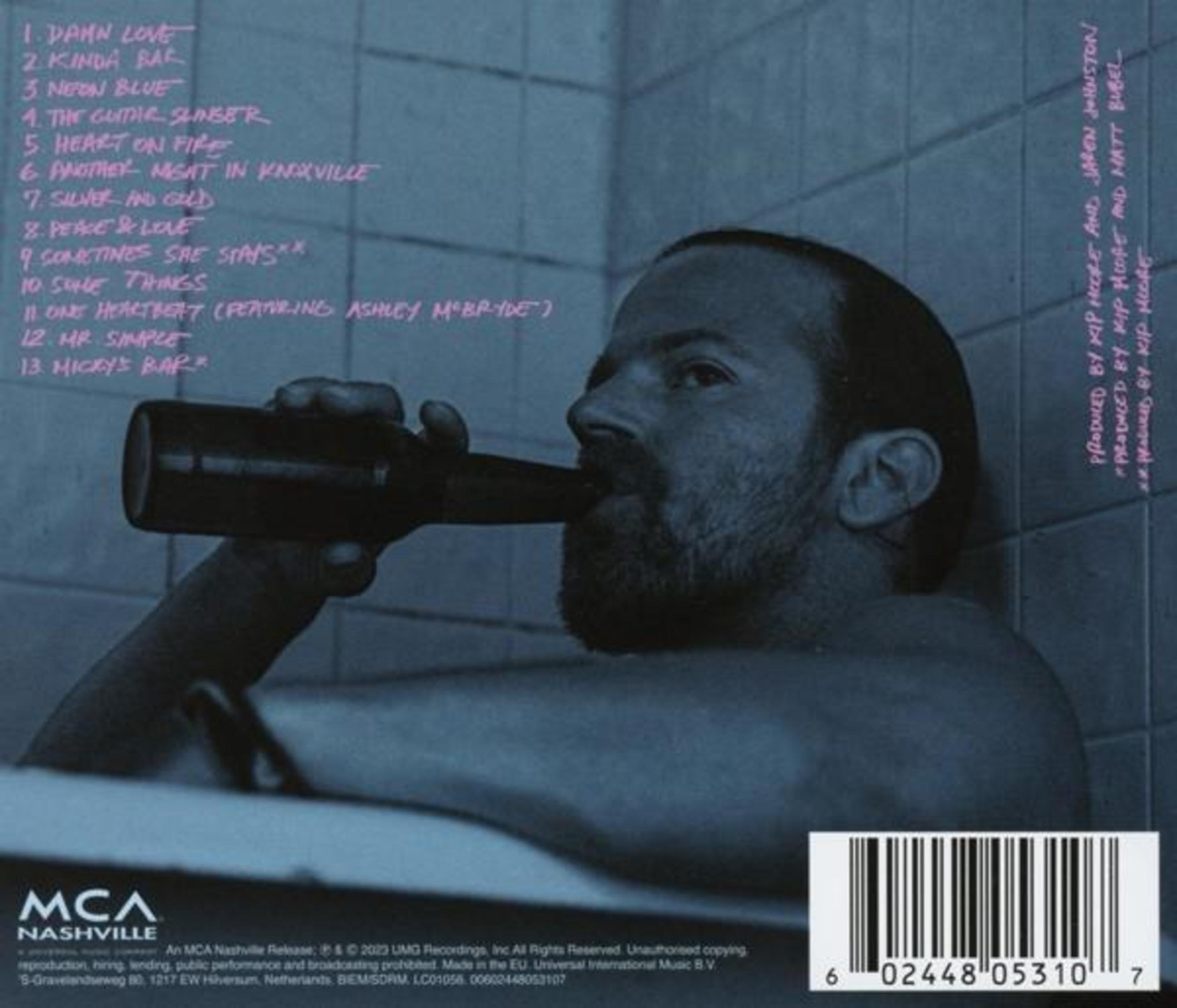 Back cover of an album: a man drinking beer in a bathtub. Song list on the left.