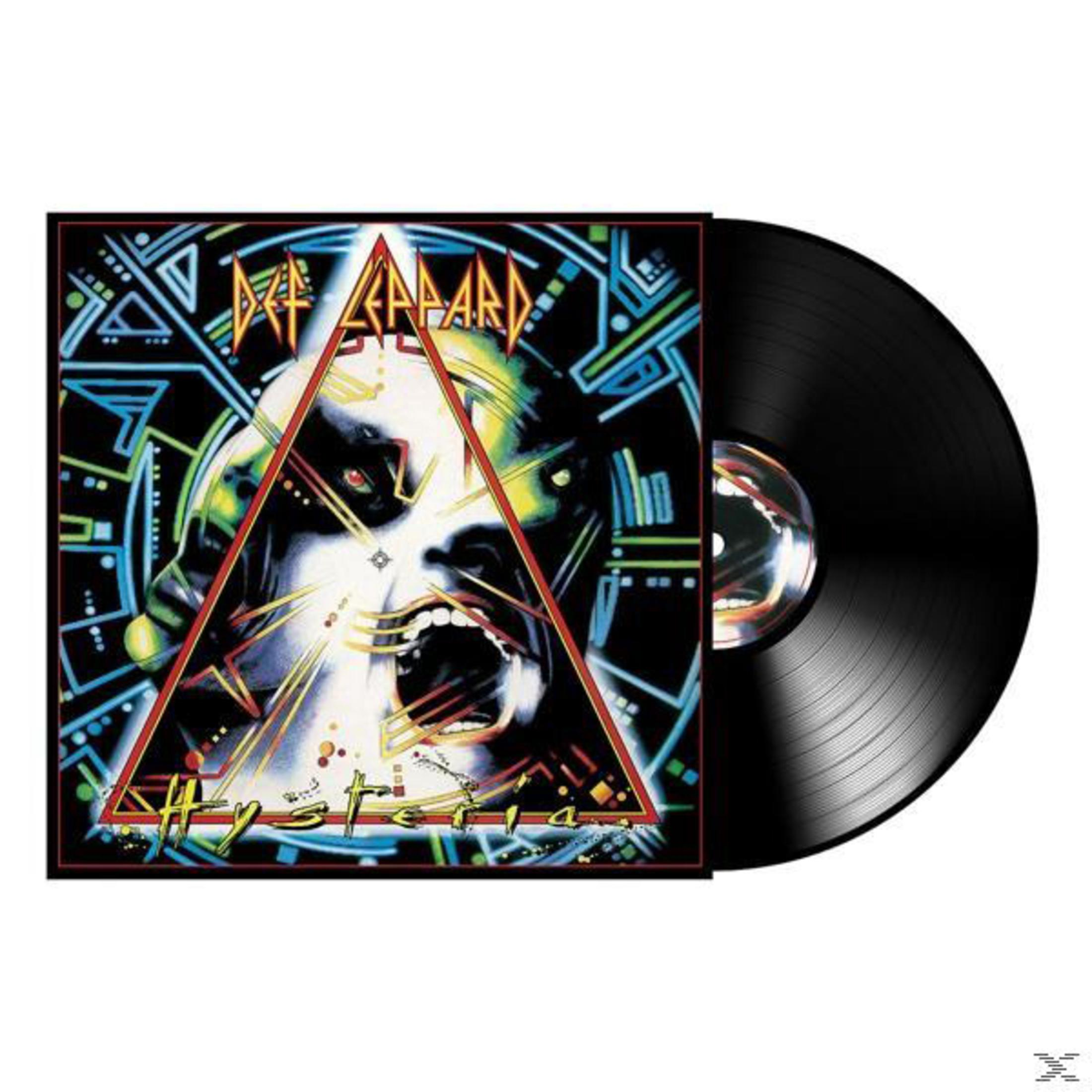 Copertina dell'album con vinile nero. Un volto è al centro della copertina. Triangoli.