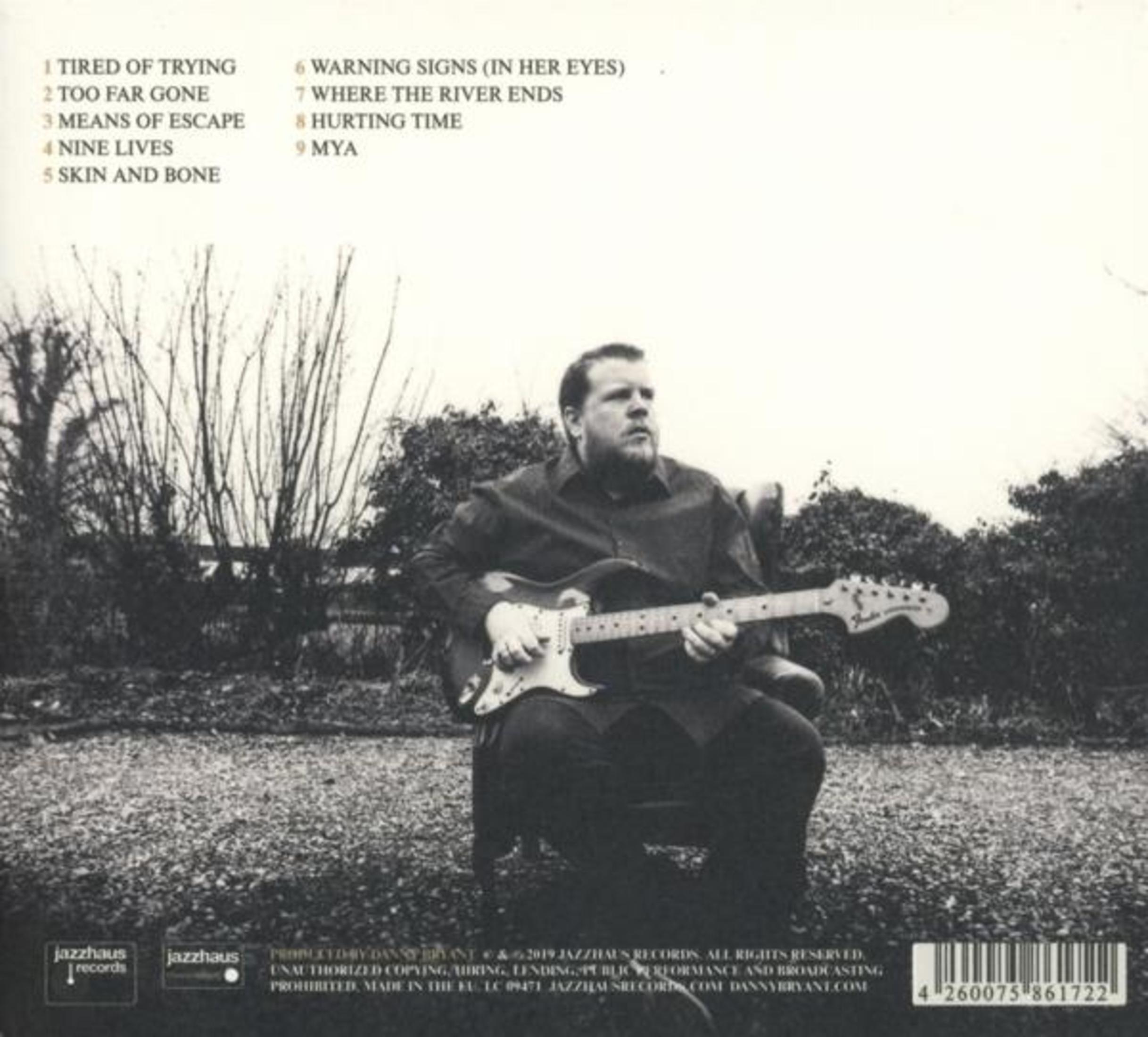 Album cover with a man playing guitar in a field. Text lists songs and credits.