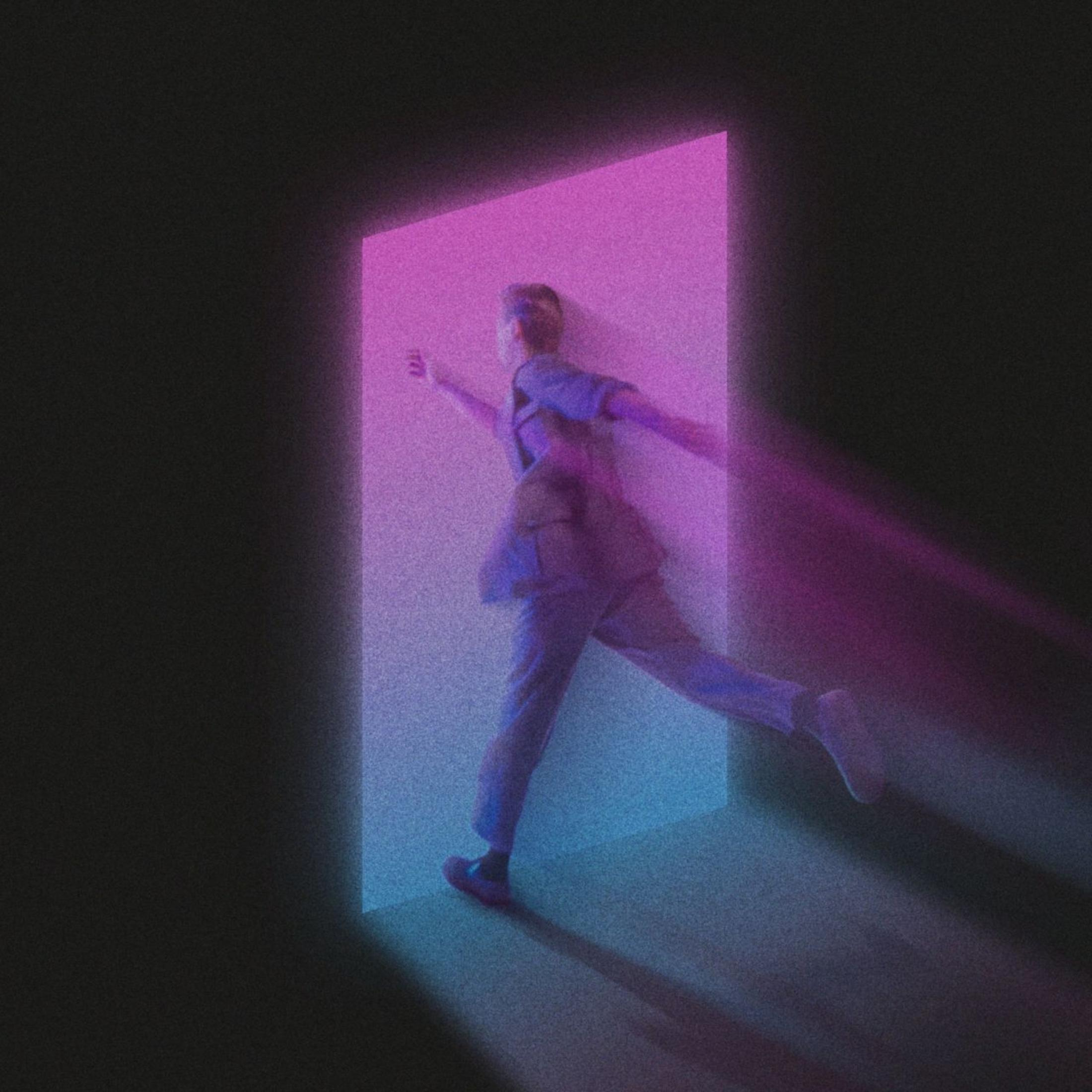 A person is stepping through a door frame with neon light. The person is in motion.