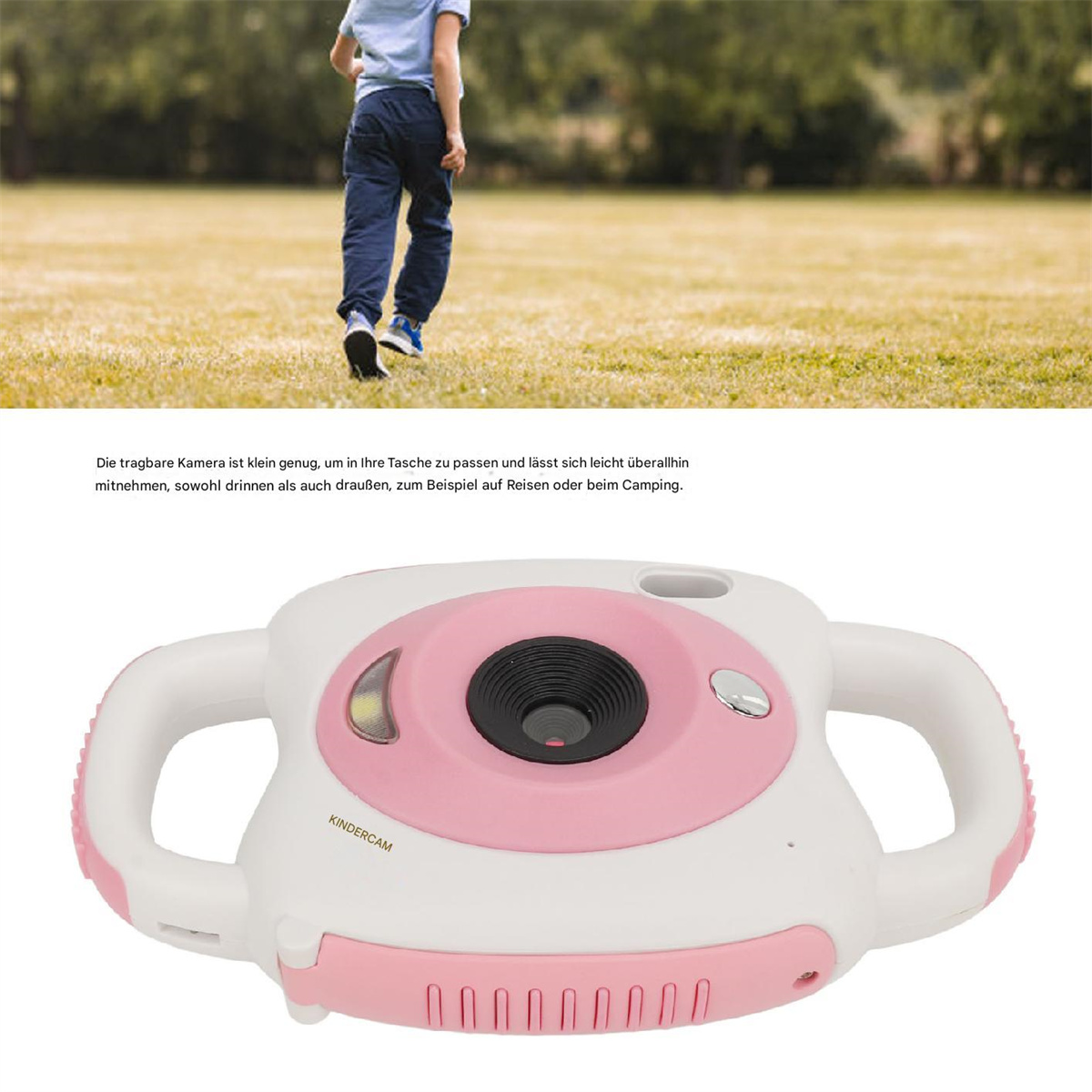 Eine rosa und weiße Spielzeugkamera mit einem Kind, das im Hintergrund auf einer Wiese rennt.