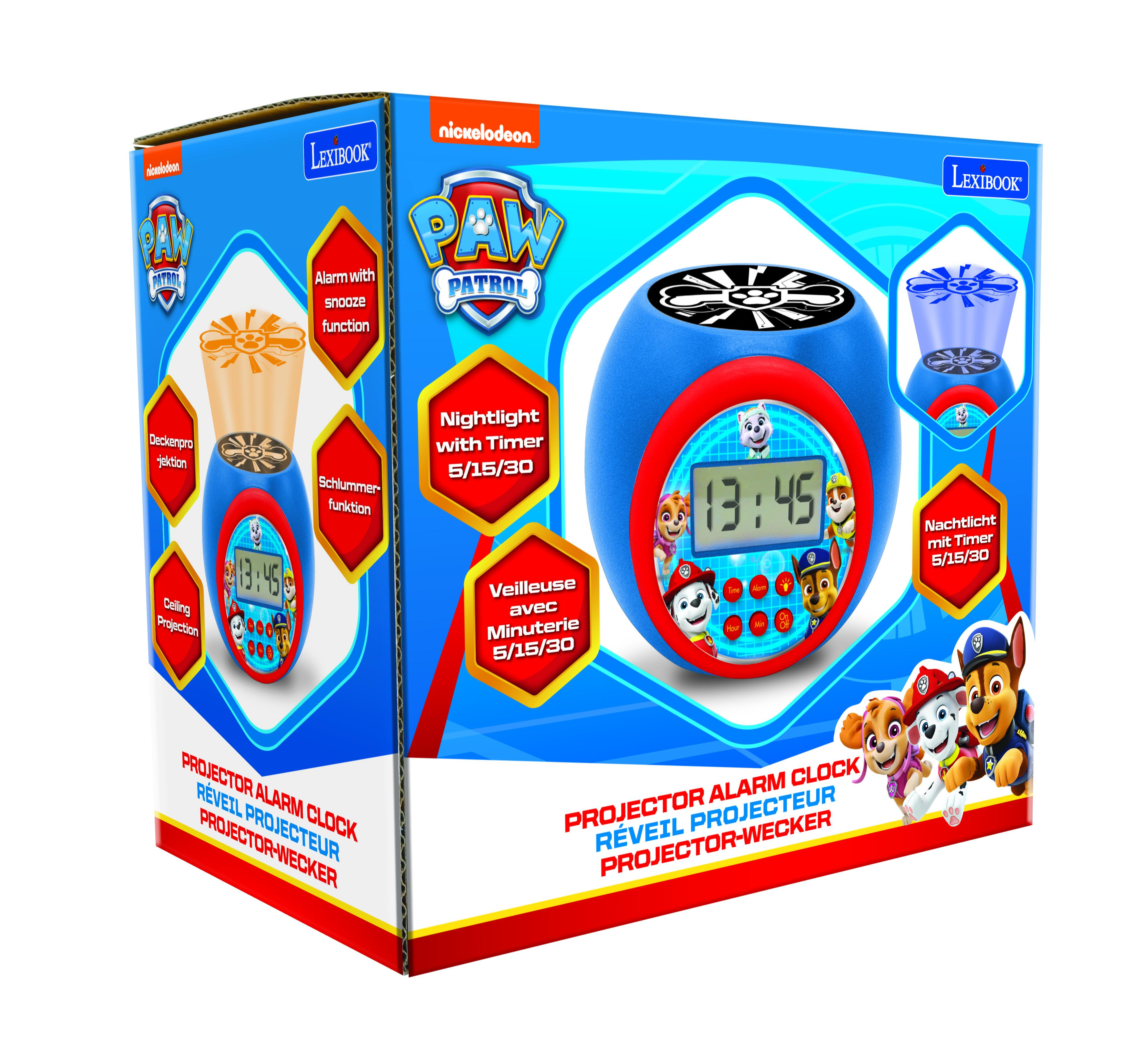 Un réveil Paw Patrol bleu, rouge et blanc dans une boîte, avec un logo Paw Patrol dessus.